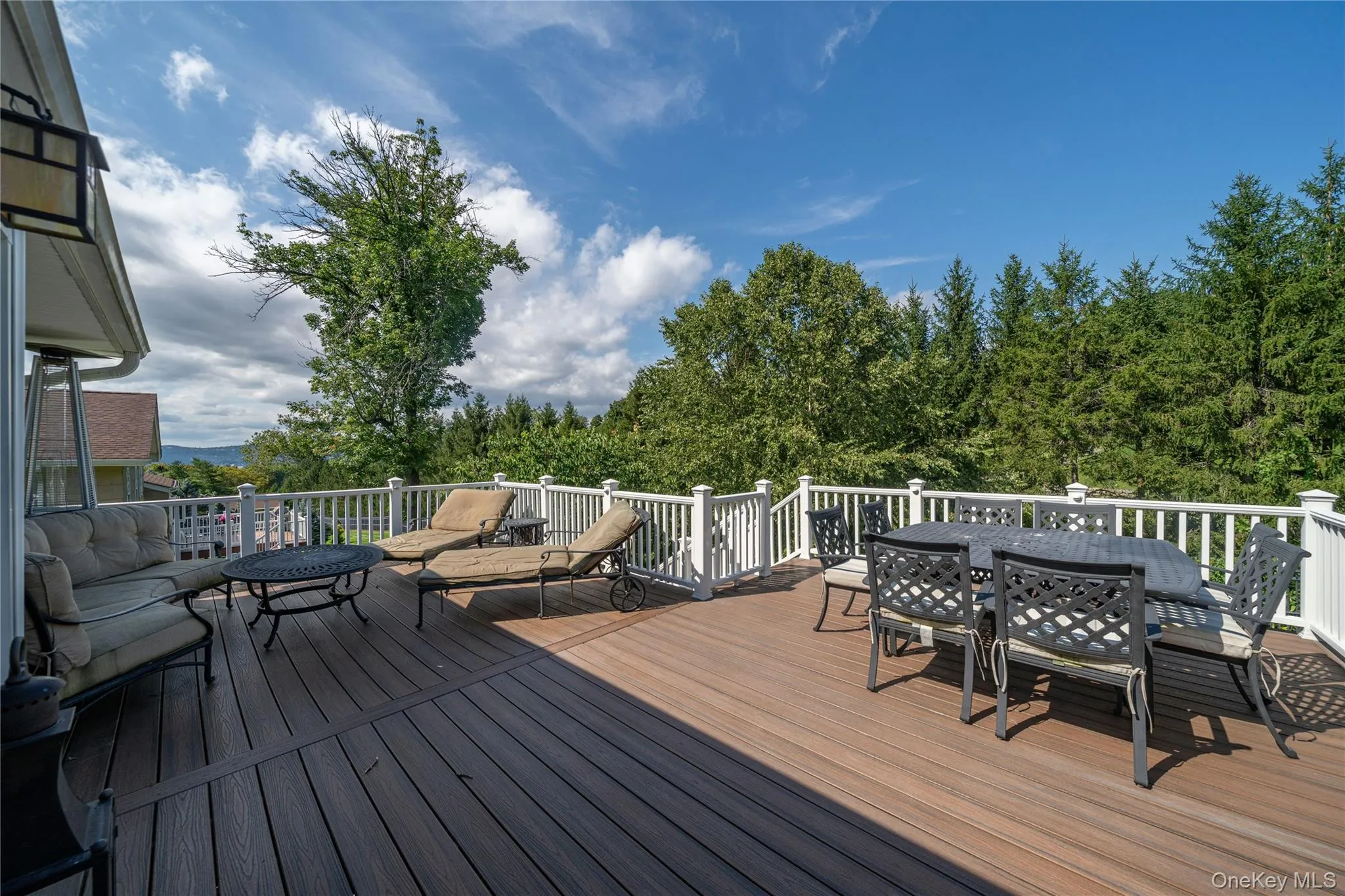 Step outside to the expansive deck, with generous space for outdoor dining and lounging while enjoying the surrounding scenery and seasonal views of the Hudson River. Step outside to the expansive deck, with generous space for outdoor dining and lounging while enjoying the surrounding scenery and seasonal views of the Hudson River.