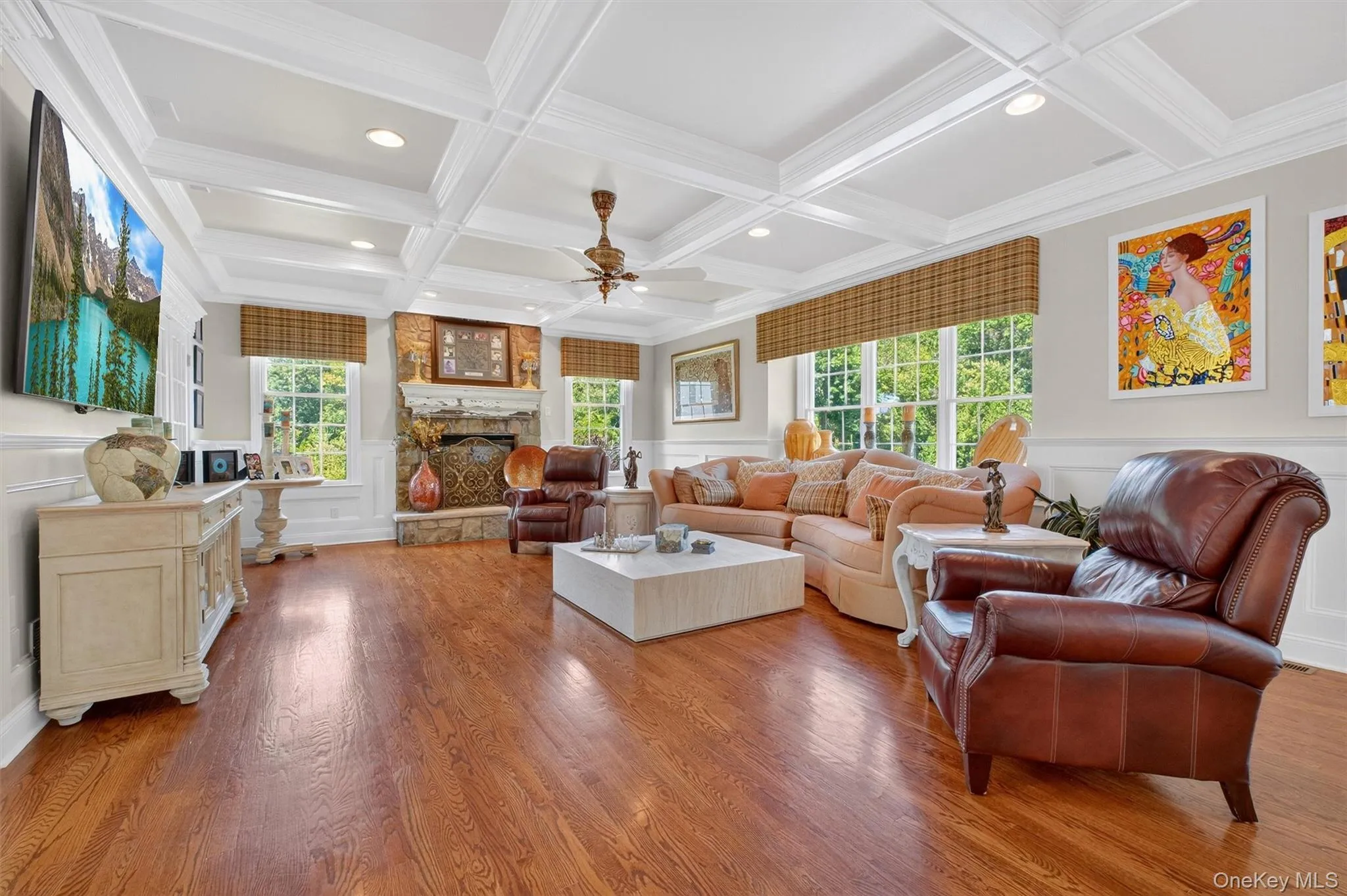 The centerpiece of this distinguished space is the elegant gas fireplace, framed by a beautifully crafted surround that anchors the room and creates a cozy focal point. Whether you’re hosting guests or enjoying a quiet evening in, the fireplace delivers both style and warmth at the touch of a button.Expansive windows ensure the family room feels open and connected to the lush outdoors, offering panoramic views and streaming natural light to enhance the airy, welcoming atmosphere. Sophisticated trim details and freshly painted walls in a soft, modern palette complete the look, offering a seamless transition from the home’s other upgraded living spaces. Every detail of this exceptional family room—from the meticulously finished hardwood underfoot to the statement ceiling above—reflects a commitment to quality and contemporary elegance, making this space a true haven for both entertaining and everyday living. The centerpiece of this distinguished space is the elegant gas fireplace, framed by a beautifully crafted surround that anchors the room and creates a cozy focal point. Whether you’re hosting guests or enjoying a quiet evening in, the fireplace delivers both style and warmth at the touch of a button.Expansive windows ensure the family room feels open and connected to the lush outdoors, offering panoramic views and streaming natural light to enhance the airy, welcoming atmosphere. Sophisticated trim details and freshly painted walls in a soft, modern palette complete the look, offering a seamless transition from the home’s other upgraded living spaces. Every detail of this exceptional family room—from the meticulously finished hardwood underfoot to the statement ceiling above—reflects a commitment to quality and contemporary elegance, making this space a true haven for both entertaining and everyday living.