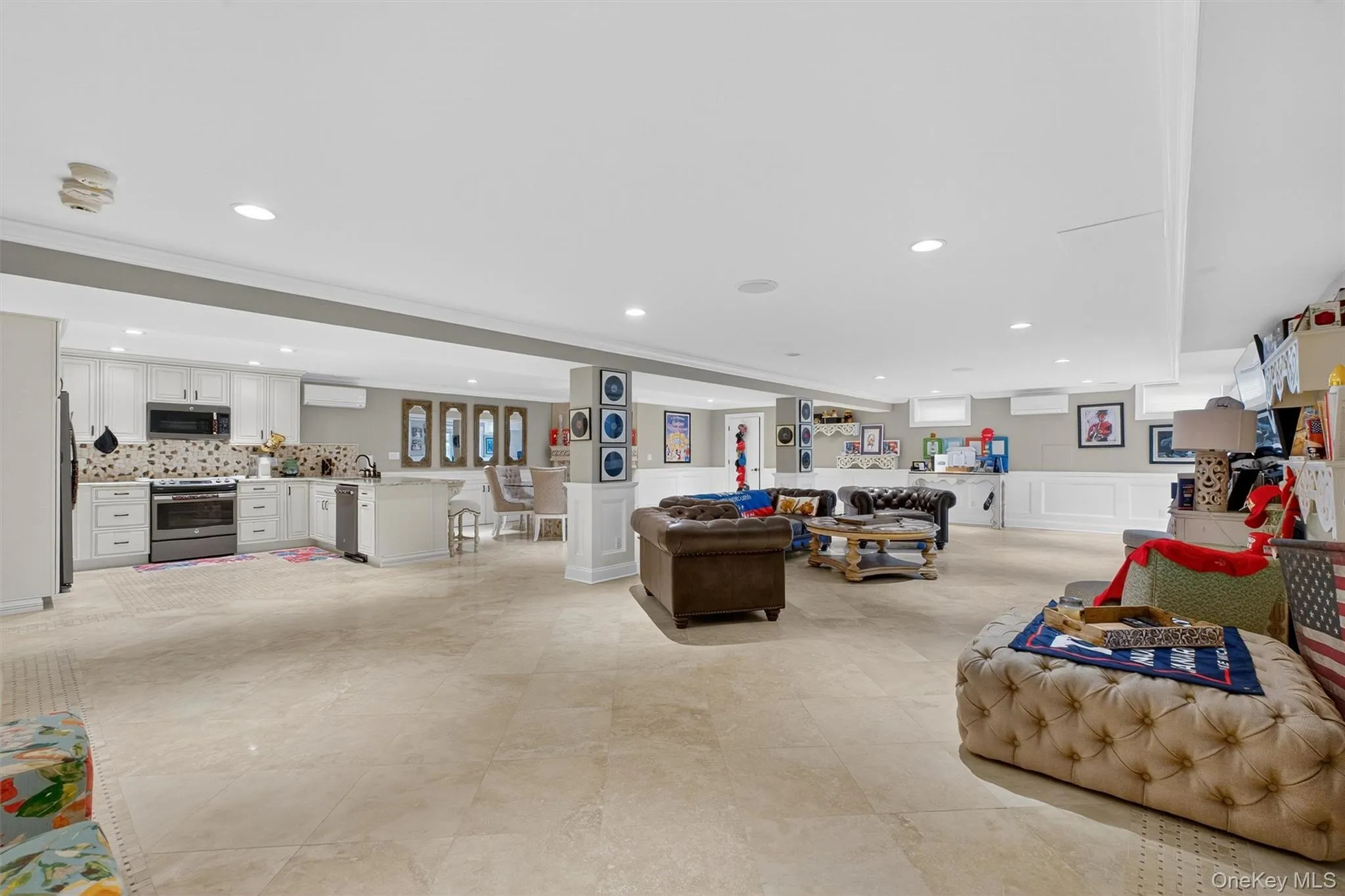 This spectacular walkout basement is fully equipped for in-law or multi-generational living, showcasing a glorious upgraded kitchen with custom cabinetry, sparkling quartz countertops, stainless sink, gas range, refrigerator, dishwasher, and microwave. The oversized limestone-patterned floors set a refined tone, while recessed lighting, surround sound, and custom wood paneling add to its elevated design. A decorative electric fireplace creates ambiance and warmth, complementing the spacious eat-in area, bar-top seating, and open living quarters. With its own dedicated heating and cooling zone, full ensuite bathroom, and secondary laundry room, this level functions as a self-sufficient retreat. Perfect for entertaining, a sliding glass door opens directly to the resort-style backyard and pool, creating an effortless flow between indoor and outdoor living. With more than 1,700+ square feet of thoughtfully designed space, it is ideal for hosting family and friends while offering comfort & versatility This spectacular walkout basement is fully equipped for in-law or multi-generational living, showcasing a glorious upgraded kitchen with custom cabinetry, sparkling quartz countertops, stainless sink, gas range, refrigerator, dishwasher, and microwave. The oversized limestone-patterned floors set a refined tone, while recessed lighting, surround sound, and custom wood paneling add to its elevated design. A decorative electric fireplace creates ambiance and warmth, complementing the spacious eat-in area, bar-top seating, and open living quarters. With its own dedicated heating and cooling zone, full ensuite bathroom, and secondary laundry room, this level functions as a self-sufficient retreat. Perfect for entertaining, a sliding glass door opens directly to the resort-style backyard and pool, creating an effortless flow between indoor and outdoor living. With more than 1,700+ square feet of thoughtfully designed space, it is ideal for hosting family and friends while offering comfort & versatility