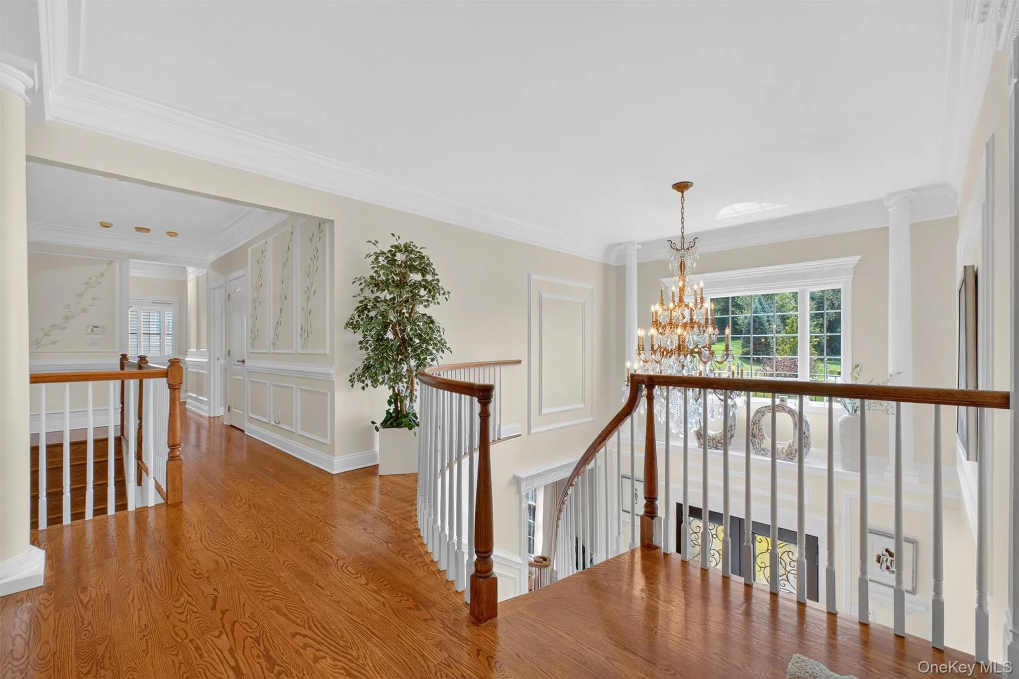Enter through the dramatic two-story foyer, where soaring ceilings, intricate crown molding, custom wall paneling, and rich hardwood floors immediately set the stage. The sweeping staircase, one of two in the home, serves as both a striking architectural focal point and a graceful connector to the upper level. At the top of the front hallway, the primary suite offers a private retreat of comfort and sophistication, while four additional bedrooms down the hall provide generous accommodations for family and guests. A central loft overlooking the two-story family room below creates a stunning vantage point and serves as the hub of the upper level, seamlessly linking the owner’s wing with the secondary bedrooms and baths. With two elegant staircases and a thoughtful layout, this home balances timeless character with modern refinement at every turn. Enter through the dramatic two-story foyer, where soaring ceilings, intricate crown molding, custom wall paneling, and rich hardwood floors immediately set the stage. The sweeping staircase, one of two in the home, serves as both a striking architectural focal point and a graceful connector to the upper level. At the top of the front hallway, the primary suite offers a private retreat of comfort and sophistication, while four additional bedrooms down the hall provide generous accommodations for family and guests. A central loft overlooking the two-story family room below creates a stunning vantage point and serves as the hub of the upper level, seamlessly linking the owner’s wing with the secondary bedrooms and baths. With two elegant staircases and a thoughtful layout, this home balances timeless character with modern refinement at every turn.