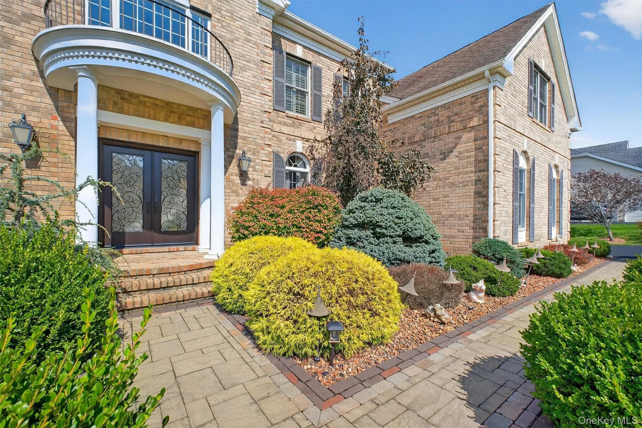 Approaching this exceptional residence, you’re greeted by a striking walkway that sets the tone for the luxury within. The stone path, meticulously crafted, guides you through lush landscaping toward an impressive double wide platform—an inviting space designed for both visual impact and practical elegance. Mature trees and vibrant plantings frame the entry, ensuring privacy and enhancing the tranquil ambiance as you arrive. At the heart of the entrance, a set of double doors stands tall, accented with obscure glass panels and crowned by a Juliet balcony above—a nod to classic architectural beauty. The brick façade, highlighted by an upgraded architectural shingle roof, exudes warmth and sophistication, while the wide platform provides ample room for guests to gather or simply pause to take in the surroundings. Every element of the entryway, from the stately red brick to the refined lines of the double doors, reflects the home’s commitment to timeless design and modern upgrades. Approaching this exceptional residence, you’re greeted by a striking walkway that sets the tone for the luxury within. The stone path, meticulously crafted, guides you through lush landscaping toward an impressive double wide platform—an inviting space designed for both visual impact and practical elegance. Mature trees and vibrant plantings frame the entry, ensuring privacy and enhancing the tranquil ambiance as you arrive. At the heart of the entrance, a set of double doors stands tall, accented with obscure glass panels and crowned by a Juliet balcony above—a nod to classic architectural beauty. The brick façade, highlighted by an upgraded architectural shingle roof, exudes warmth and sophistication, while the wide platform provides ample room for guests to gather or simply pause to take in the surroundings. Every element of the entryway, from the stately red brick to the refined lines of the double doors, reflects the home’s commitment to timeless design and modern upgrades.