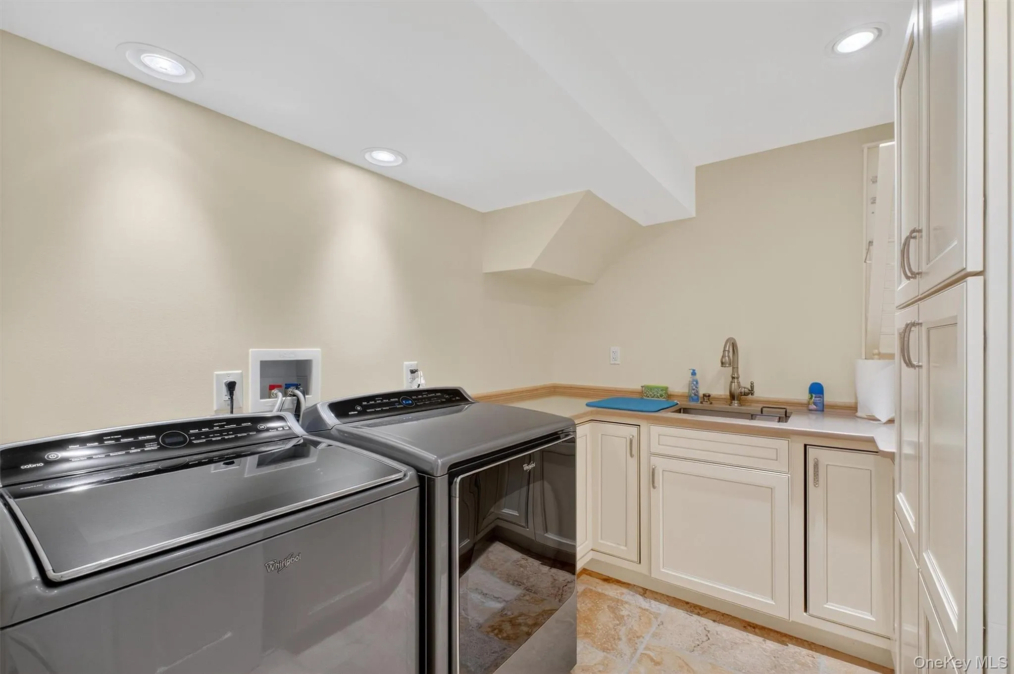 The basement level also features a full laundry room designed with both style and function in mind. Outfitted with a practically new front-loading washer and dryer, this space includes custom cabinetry, a deep utility sink, and ample countertop space for folding. Built-in storage adds convenience and organization, making laundry tasks efficient and effortless. Thoughtfully finished to the same high standard as the rest of the level, this laundry room enhances the basement’s self-sufficient appeal for in-law or multi-generational living. The basement level also features a full laundry room designed with both style and function in mind. Outfitted with a practically new front-loading washer and dryer, this space includes custom cabinetry, a deep utility sink, and ample countertop space for folding. Built-in storage adds convenience and organization, making laundry tasks efficient and effortless. Thoughtfully finished to the same high standard as the rest of the level, this laundry room enhances the basement’s self-sufficient appeal for in-law or multi-generational living.