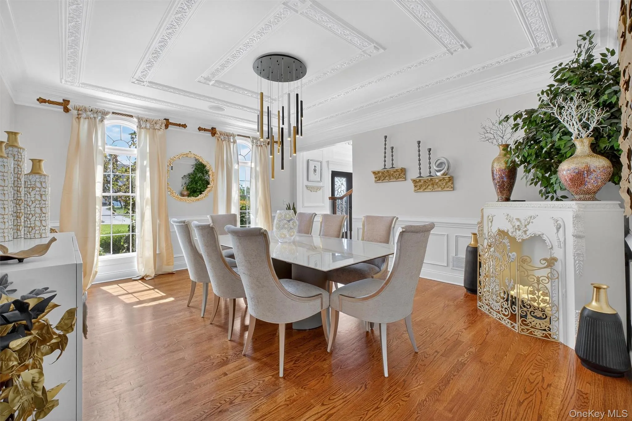 This elegant dining room is a timeless showpiece, blending classic architectural details with modern sophistication. Intricate ceiling moldings and wainscoting add a sense of grandeur, while oversized windows allow natural light to pour in, highlighting the room’s beauty. The space easily accommodates a large dining table, offering plenty of room for the whole family to gather for holidays and celebrations. With its original charm preserved and enhanced by thoughtful updates, this dining room is both welcoming and refined—a perfect balance of tradition and style that will never go out of fashion. This elegant dining room is a timeless showpiece, blending classic architectural details with modern sophistication. Intricate ceiling moldings and wainscoting add a sense of grandeur, while oversized windows allow natural light to pour in, highlighting the room’s beauty. The space easily accommodates a large dining table, offering plenty of room for the whole family to gather for holidays and celebrations. With its original charm preserved and enhanced by thoughtful updates, this dining room is both welcoming and refined—a perfect balance of tradition and style that will never go out of fashion.