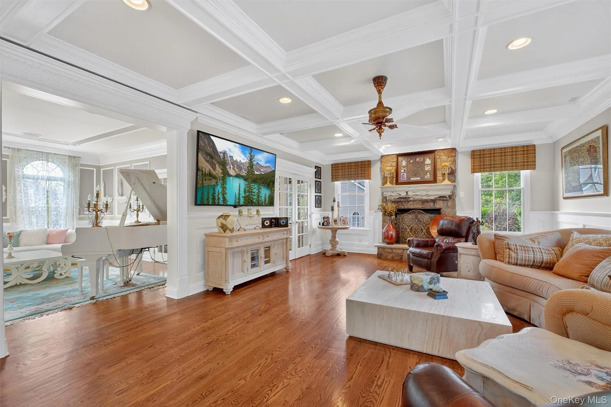 Experience the heart of luxury living in this spectacular family room—a seamless blend of comfort, sophistication, and modern upgrades. Sunlight streams across the stunning, wide-plank hardwood floors, accentuating the room’s generous proportions and inviting ambiance. A dramatic coffered ceiling adds architectural interest and a sense of grandeur, while recessed lighting casts a warm, ambient glow perfect for relaxing evenings or lively gatherings. Experience the heart of luxury living in this spectacular family room—a seamless blend of comfort, sophistication, and modern upgrades. Sunlight streams across the stunning, wide-plank hardwood floors, accentuating the room’s generous proportions and inviting ambiance. A dramatic coffered ceiling adds architectural interest and a sense of grandeur, while recessed lighting casts a warm, ambient glow perfect for relaxing evenings or lively gatherings.