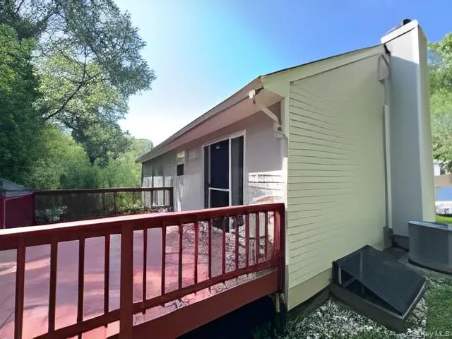 View of side of home with a deck and a chimney View of side of home with a deck and a chimney