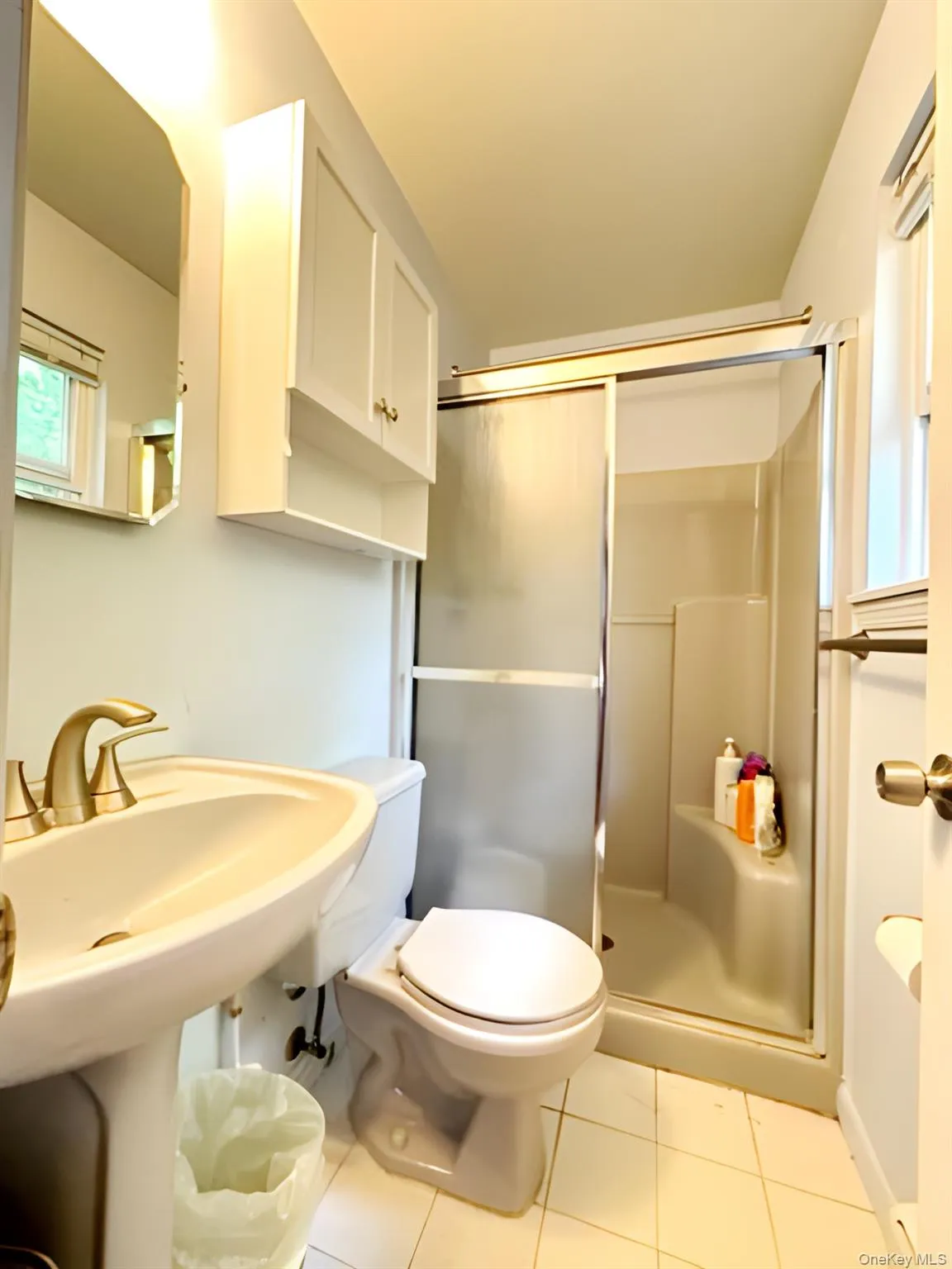 Bathroom with a stall shower and tile patterned flooring Bathroom with a stall shower and tile patterned flooring