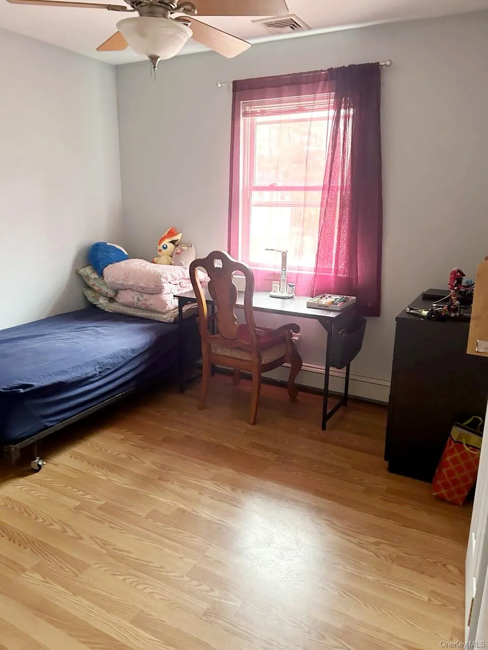Bedroom featuring light wood-style flooring and a ceiling fan Bedroom featuring light wood-style flooring and a ceiling fan