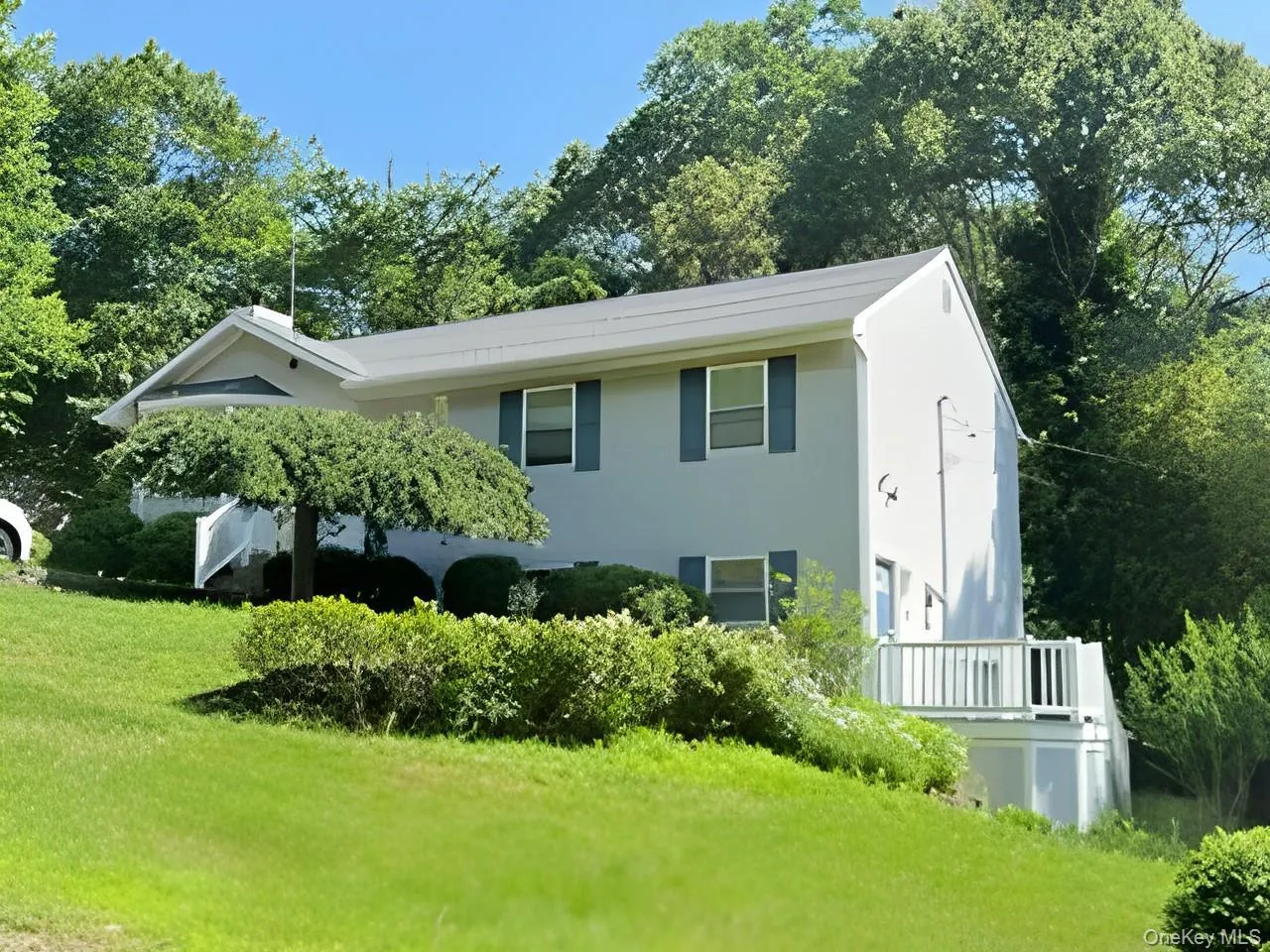 View of side of home with a yard and stucco siding View of side of home with a yard and stucco siding