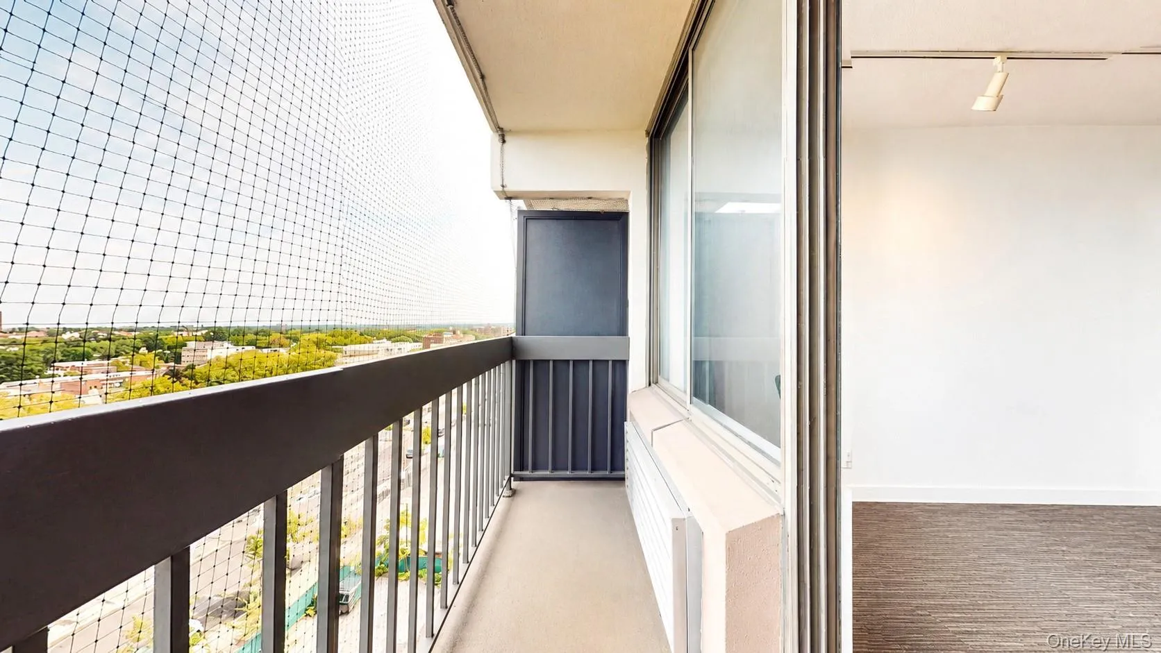 Balcony with metal railing, new protective netting, and sliding glass door Balcony with metal railing, new protective netting, and sliding glass door