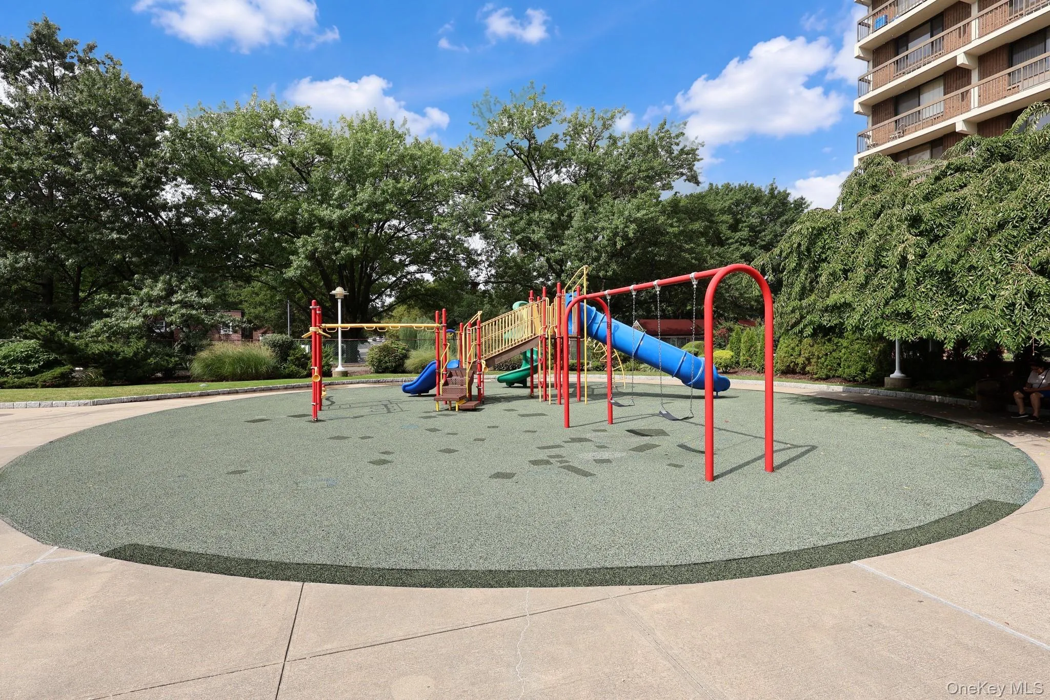 Playground with rubberized surfacing, swings, and slides Playground with rubberized surfacing, swings, and slides