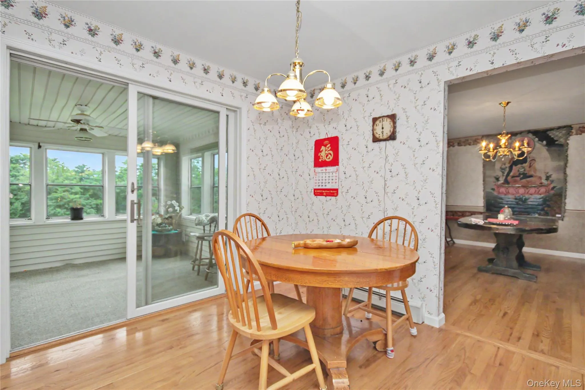 Kitchen Dining Area with Sliders open to Sun Room Kitchen Dining Area with Sliders open to Sun Room