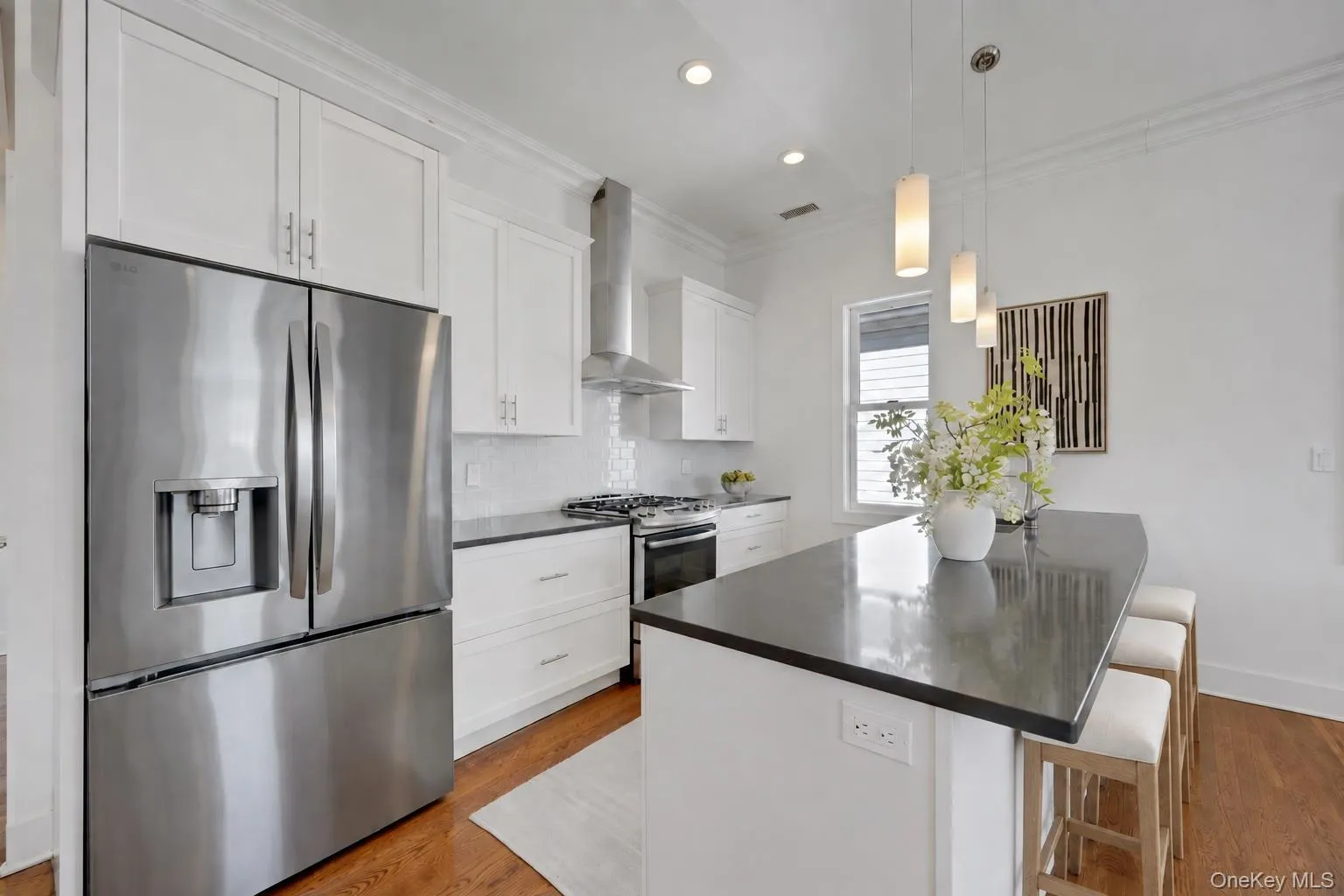 Modern kitchen with white maple wood cabinetry, glass tile backsplash and stainless appliances. Modern kitchen with white maple wood cabinetry, glass tile backsplash and stainless appliances.