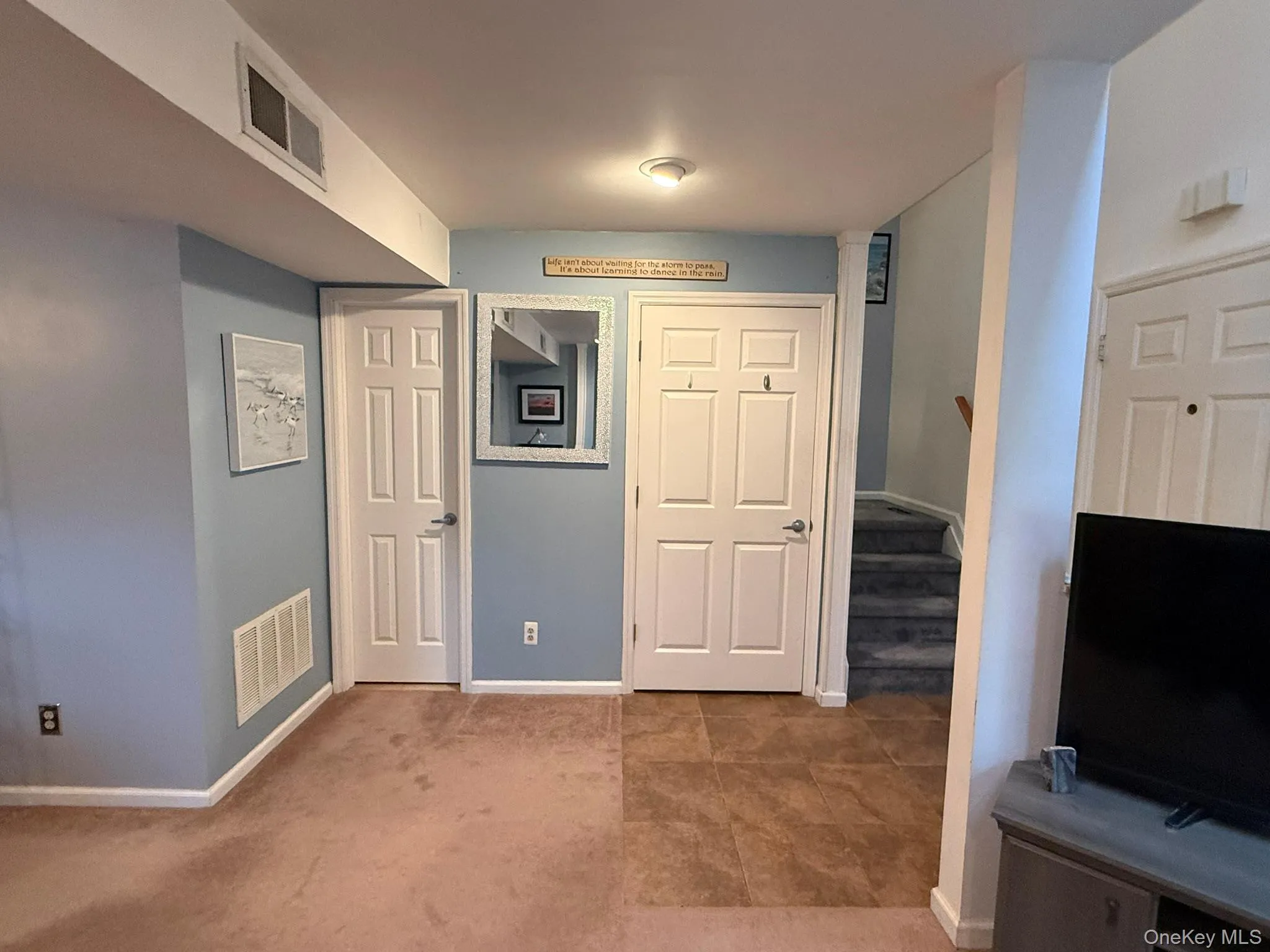 1/2 bath on the left and closet on the right with stairs leading to 2nd floor 1/2 bath on the left and closet on the right with stairs leading to 2nd floor