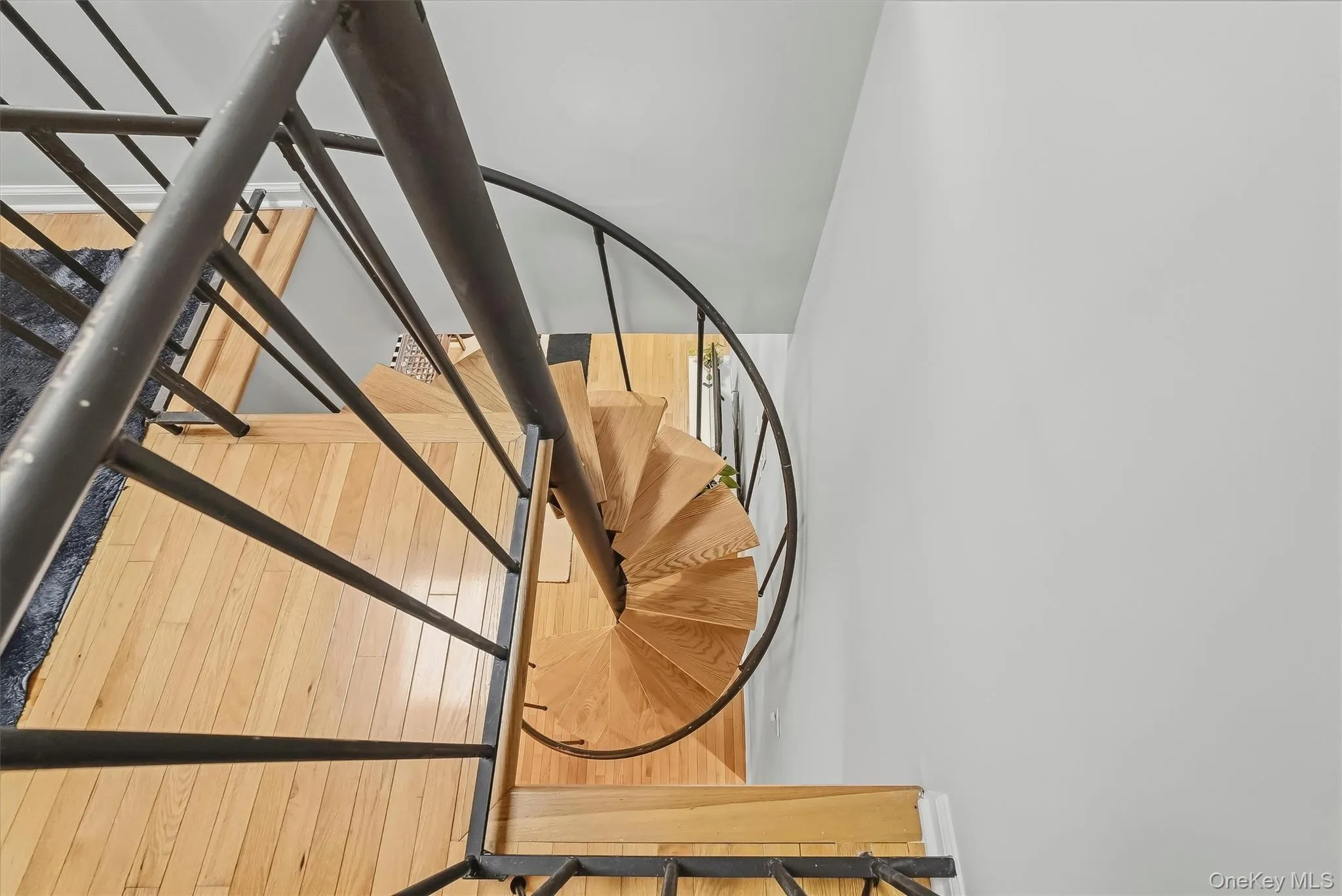 Statement spiral staircase adds architectural character and leads to the upper loft. Statement spiral staircase adds architectural character and leads to the upper loft.