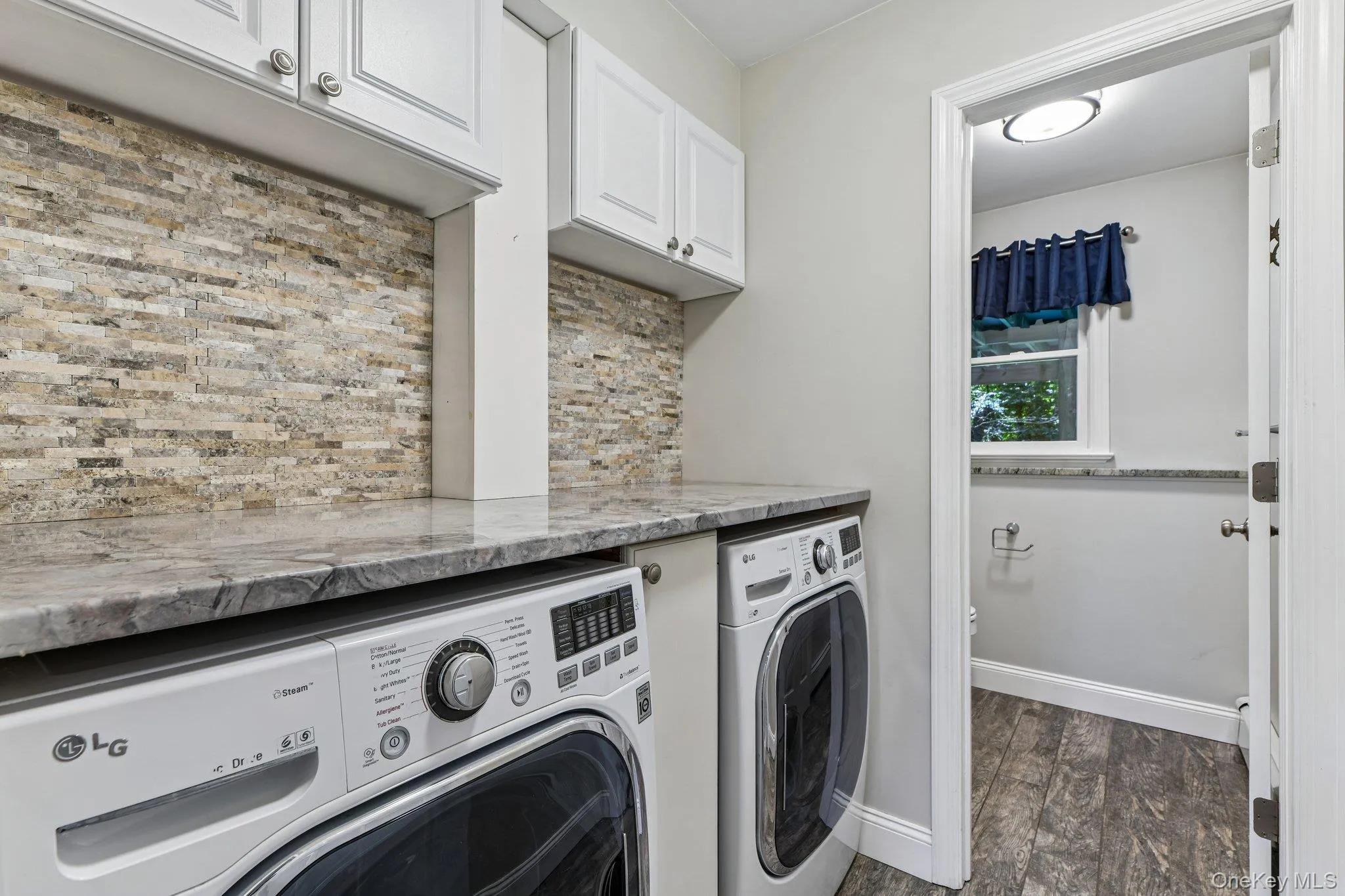 Laundry room with access to a half bathroom on the first floor Laundry room with access to a half bathroom on the first floor