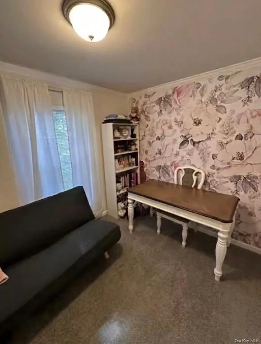 Ceiling-mounted light fixture, crown molding, floral accent wall, and wall-to-wall carpeting. Ceiling-mounted light fixture, crown molding, floral accent wall, and wall-to-wall carpeting.