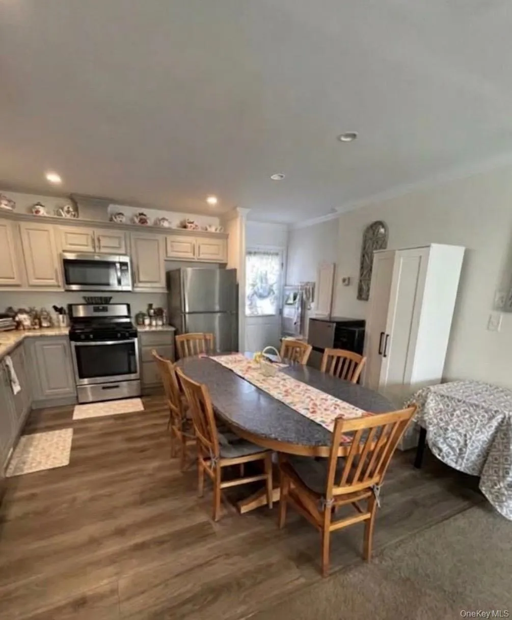 Kitchen with stainless steel appliances, grey cabinetry, and recessed lighting. Kitchen with stainless steel appliances, grey cabinetry, and recessed lighting.