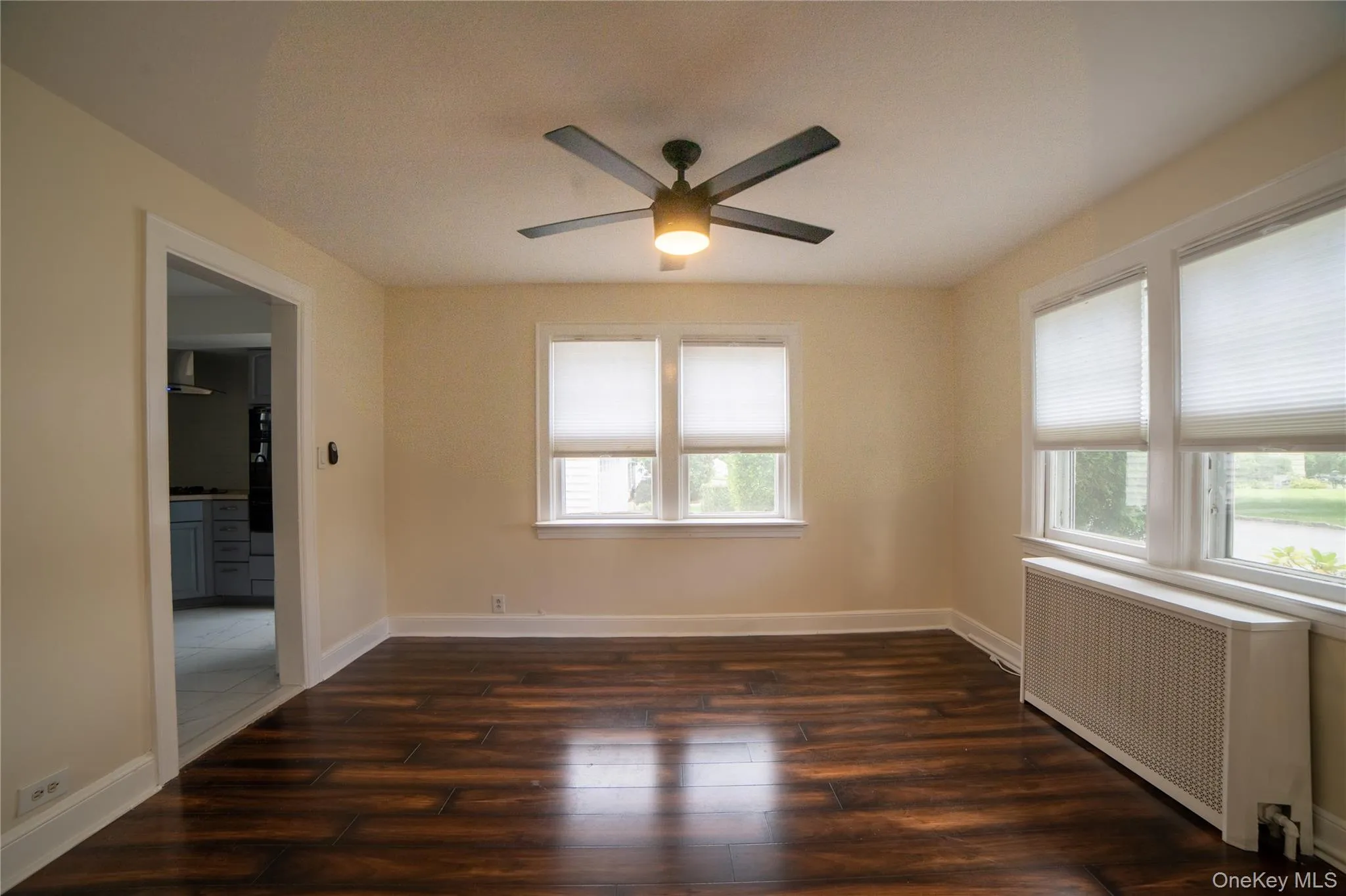 Dining room with ceiling fan and window blinds already in place and leading to the kitchen. Dining room with ceiling fan and window blinds already in place and leading to the kitchen.