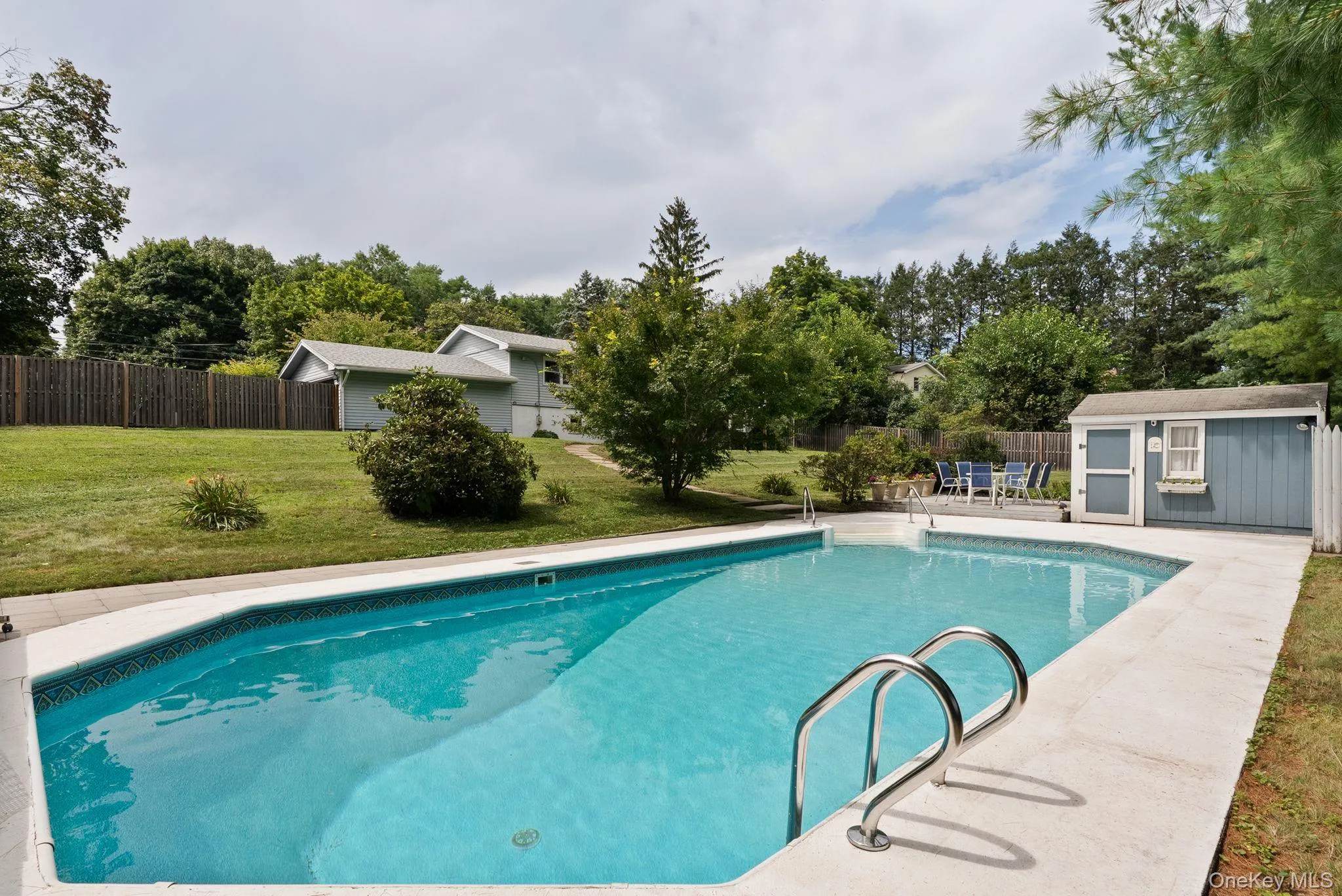 In-ground swimming pool with concrete surround In-ground swimming pool with concrete surround