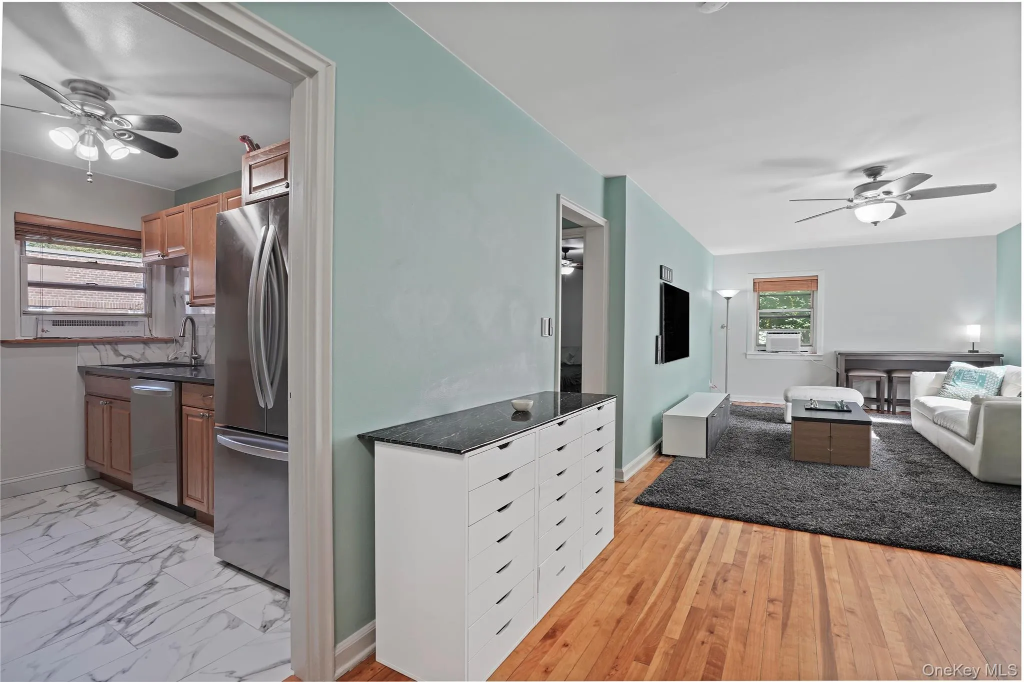 View from entry foyer into kitchen and towards living space. View from entry foyer into kitchen and towards living space.