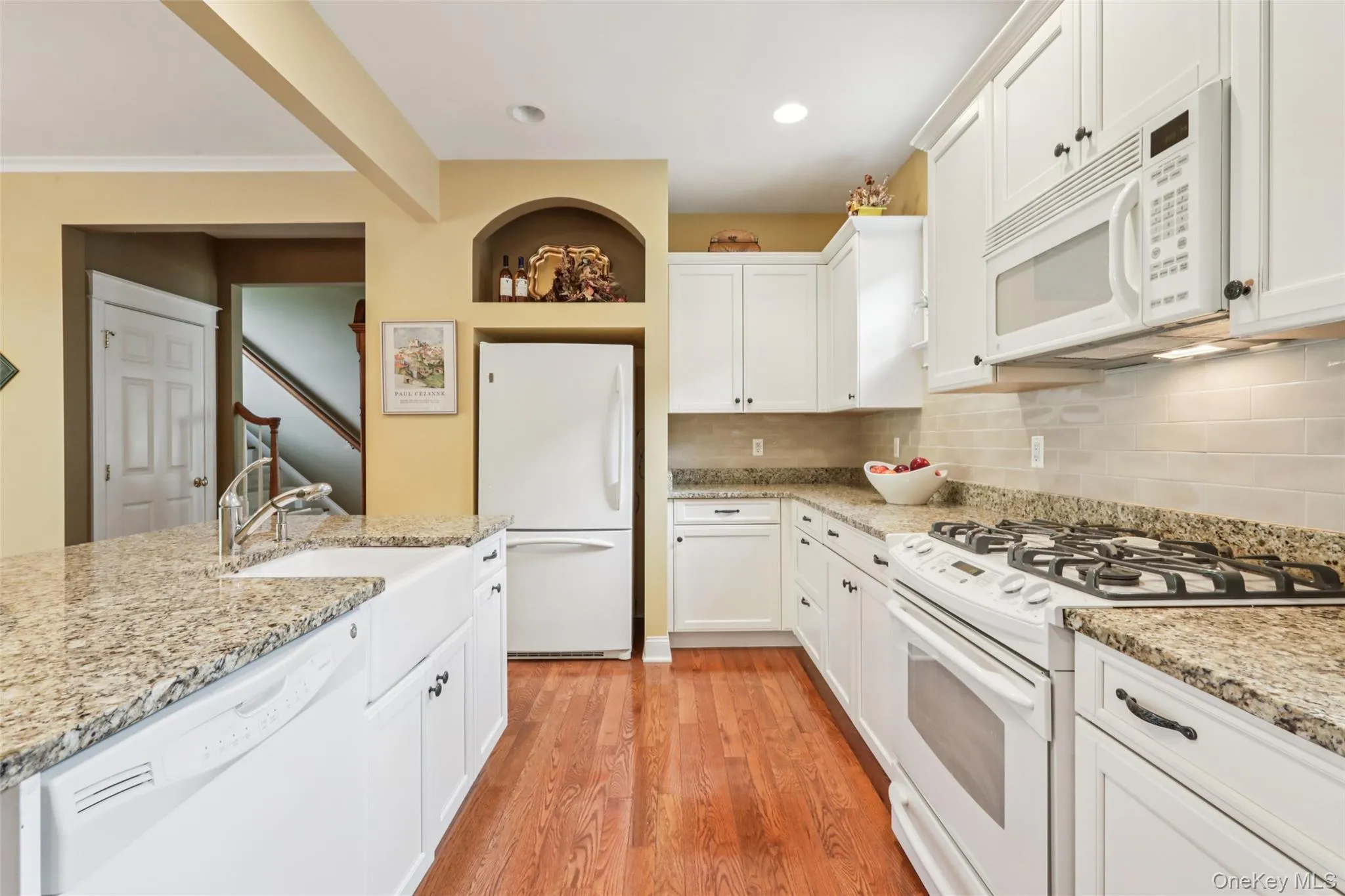 Kitchen with a farmhouse sink and granite countertops Kitchen with a farmhouse sink and granite countertops