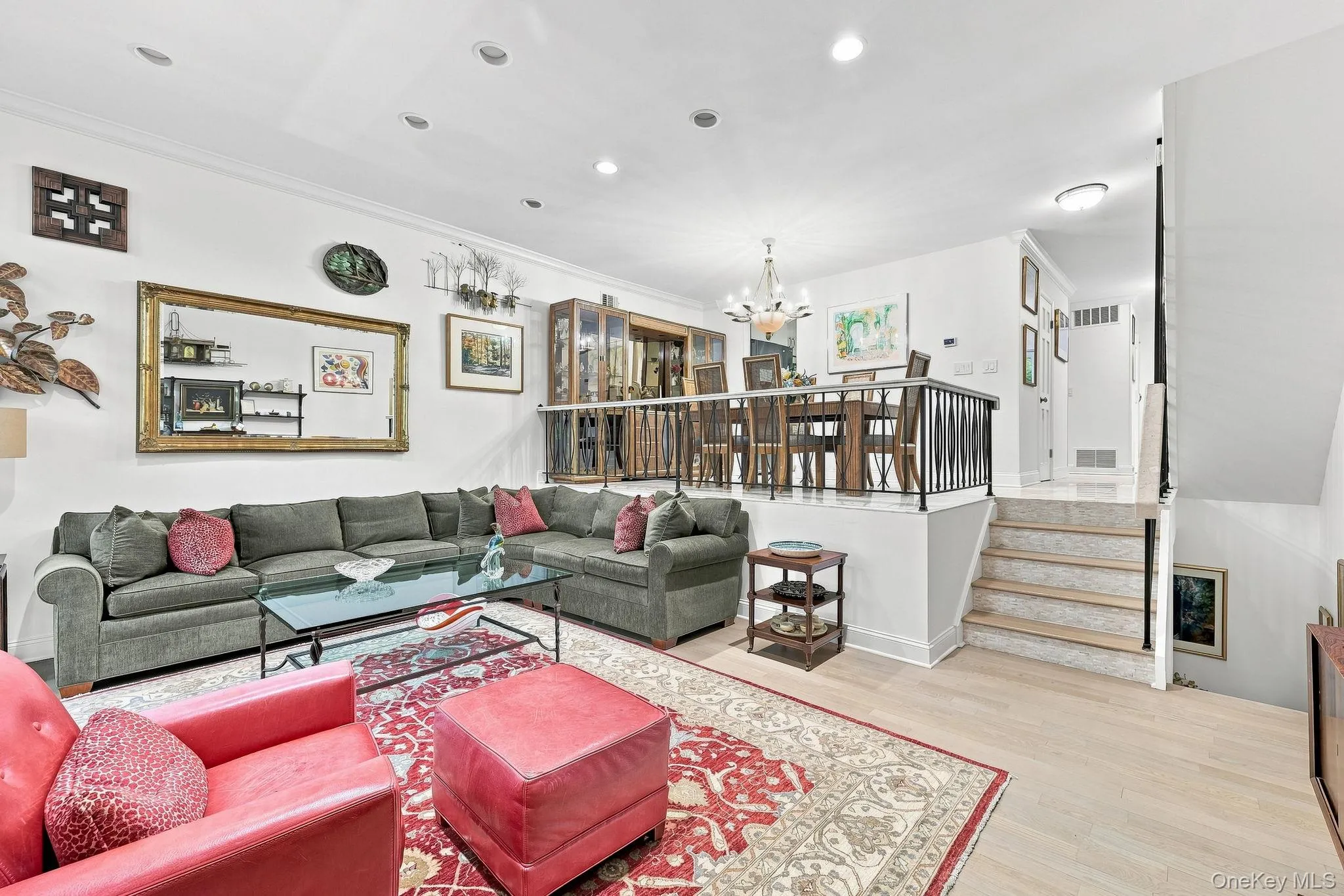 Step down to the living room with its solid white oak floors, deep baseboards and crown moldings Step down to the living room with its solid white oak floors, deep baseboards and crown moldings