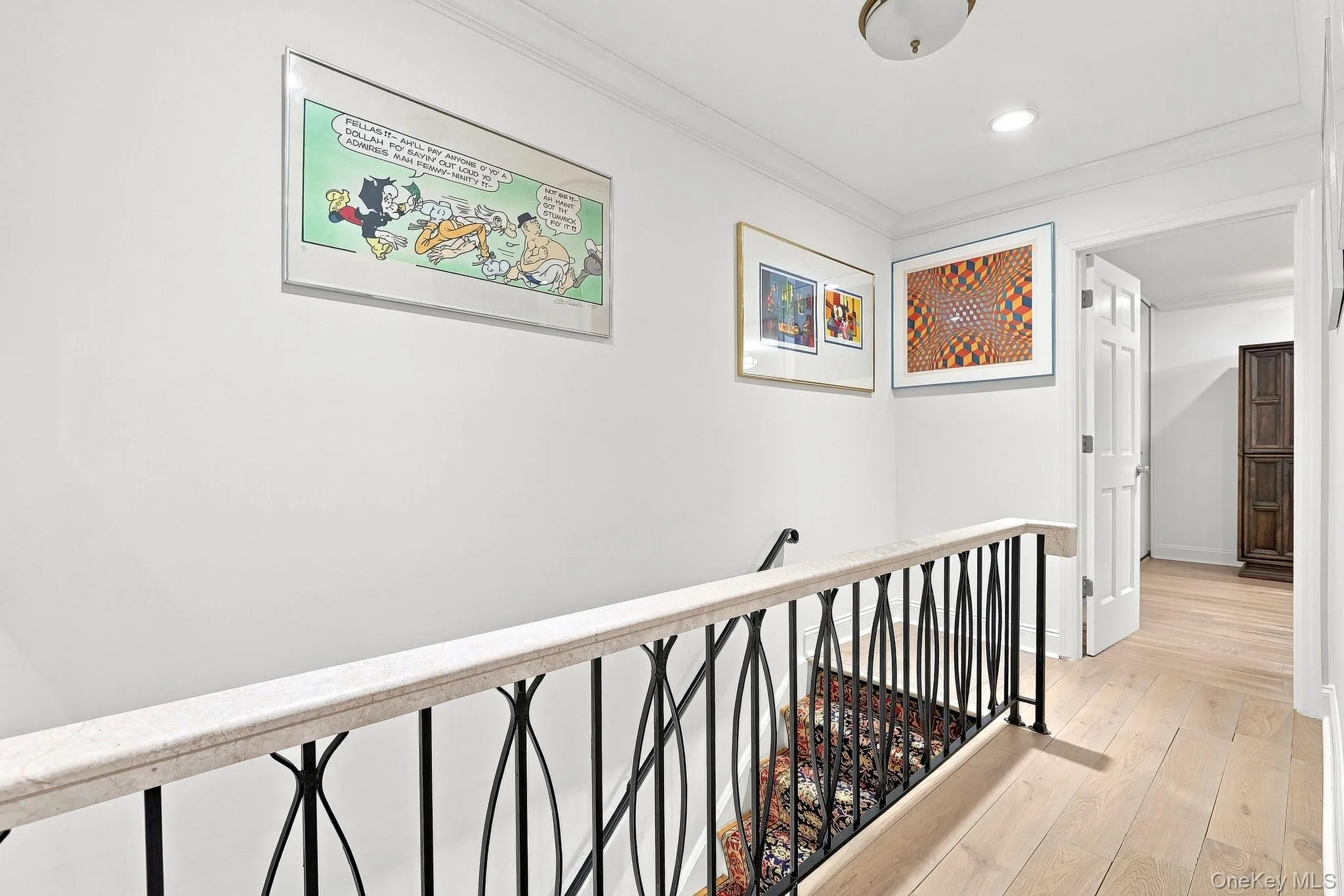 The stairs to the second floor showcase the Crema Marfil stone on the iron railing at the landing The stairs to the second floor showcase the Crema Marfil stone on the iron railing at the landing
