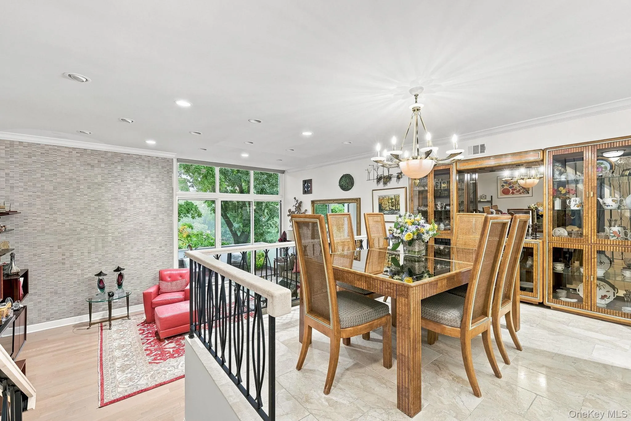 The sizeable dining area supports a large hutch within, and the chandelier is included in the sale The sizeable dining area supports a large hutch within, and the chandelier is included in the sale