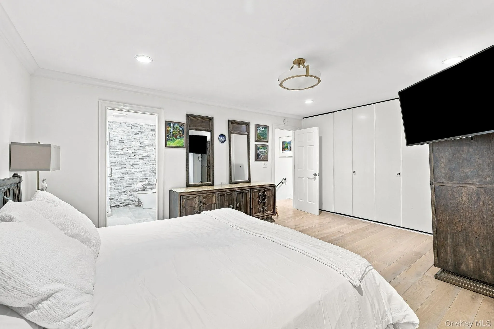 There is an entire wall of custom designed closets and you see here the entrance into the ensuite bathroom There is an entire wall of custom designed closets and you see here the entrance into the ensuite bathroom