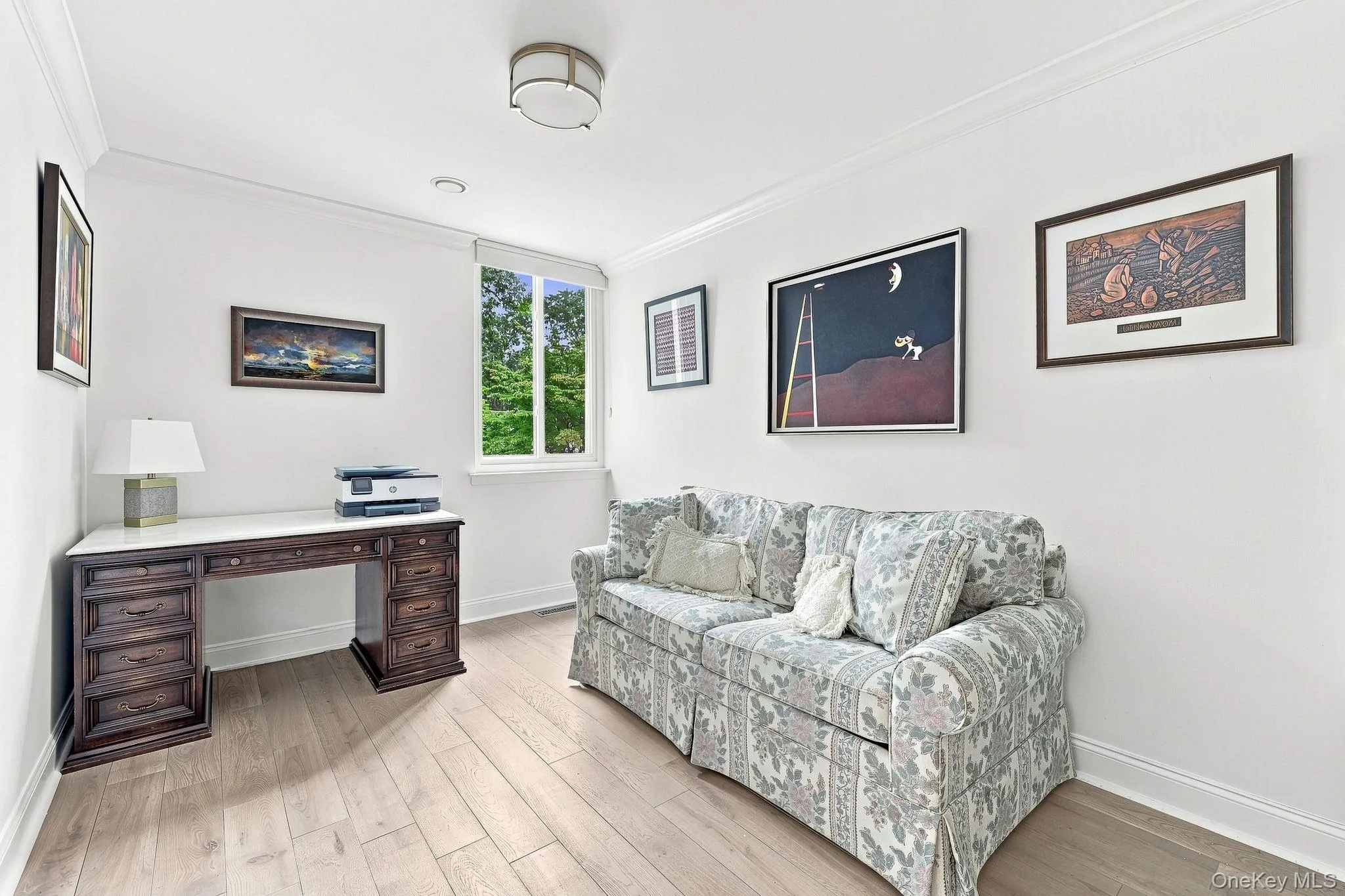 The third bedroom with a Hunter Douglas shade on the window overlooking the courtyardhas a center ceiling light fixture The third bedroom with a Hunter Douglas shade on the window overlooking the courtyardhas a center ceiling light fixture