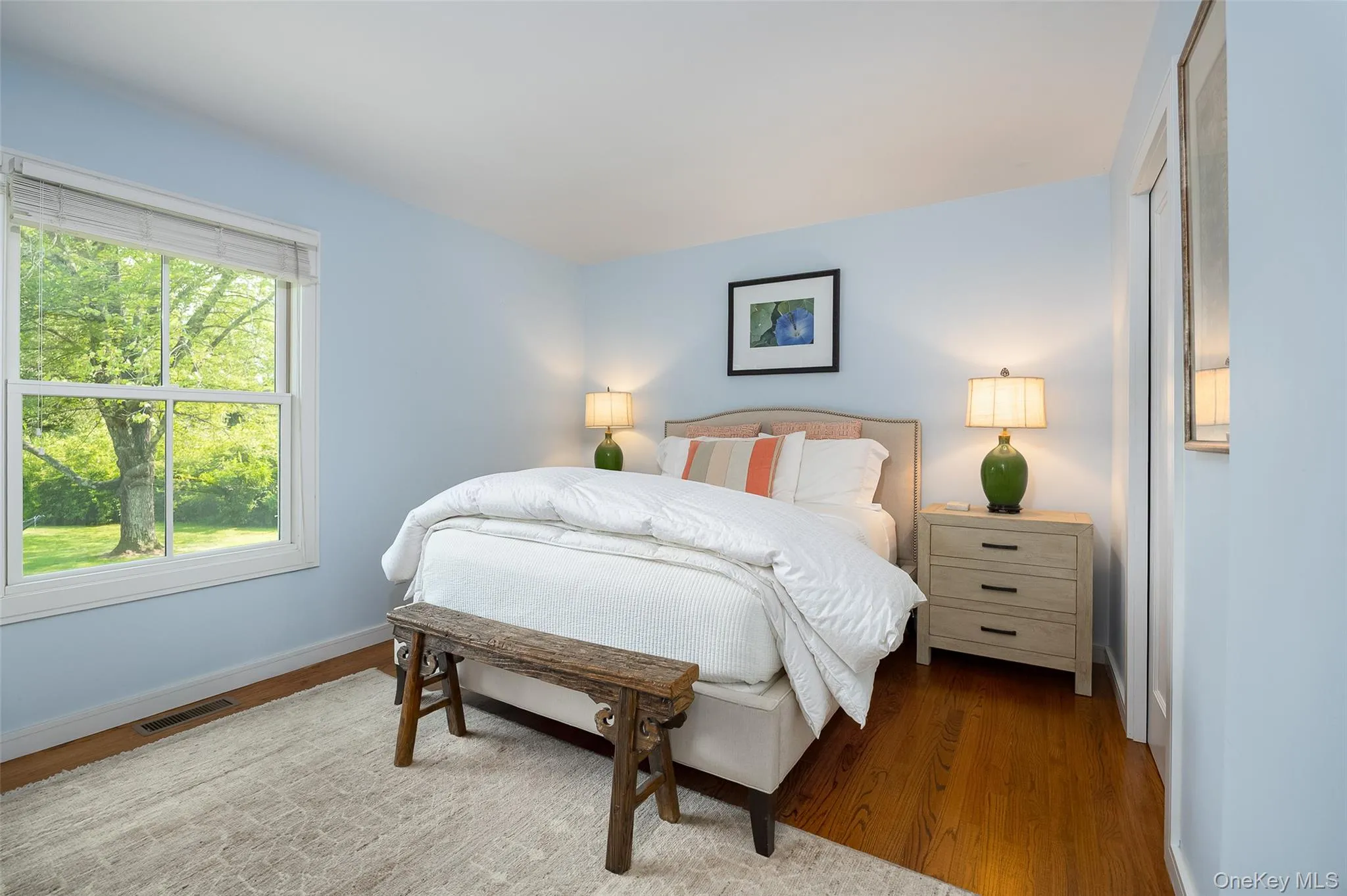 Primary bedroom with bucolic back yard view Primary bedroom with bucolic back yard view