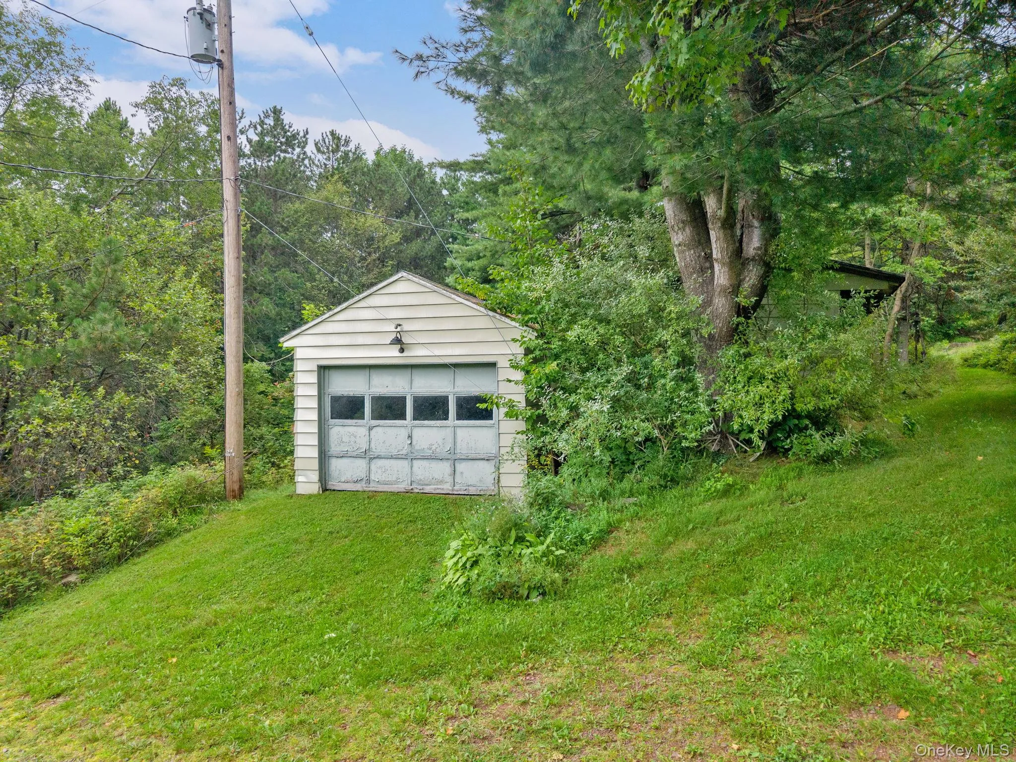 Detached garage with horizontal siding and an overhead door Detached garage with horizontal siding and an overhead door