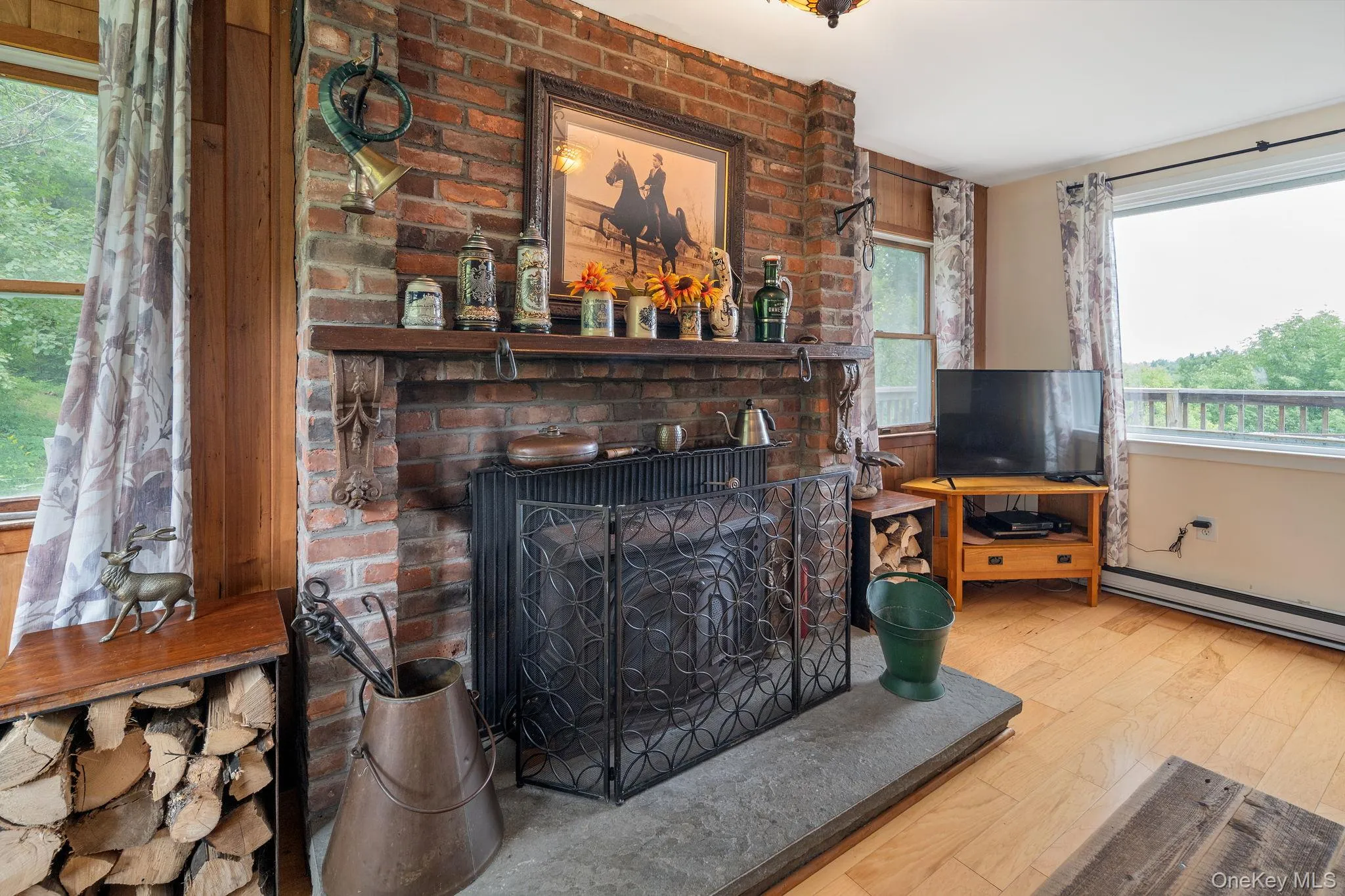 Brick-faced fireplace with a stone hearth, wood mantle, and an integrated wood storage niche Brick-faced fireplace with a stone hearth, wood mantle, and an integrated wood storage niche