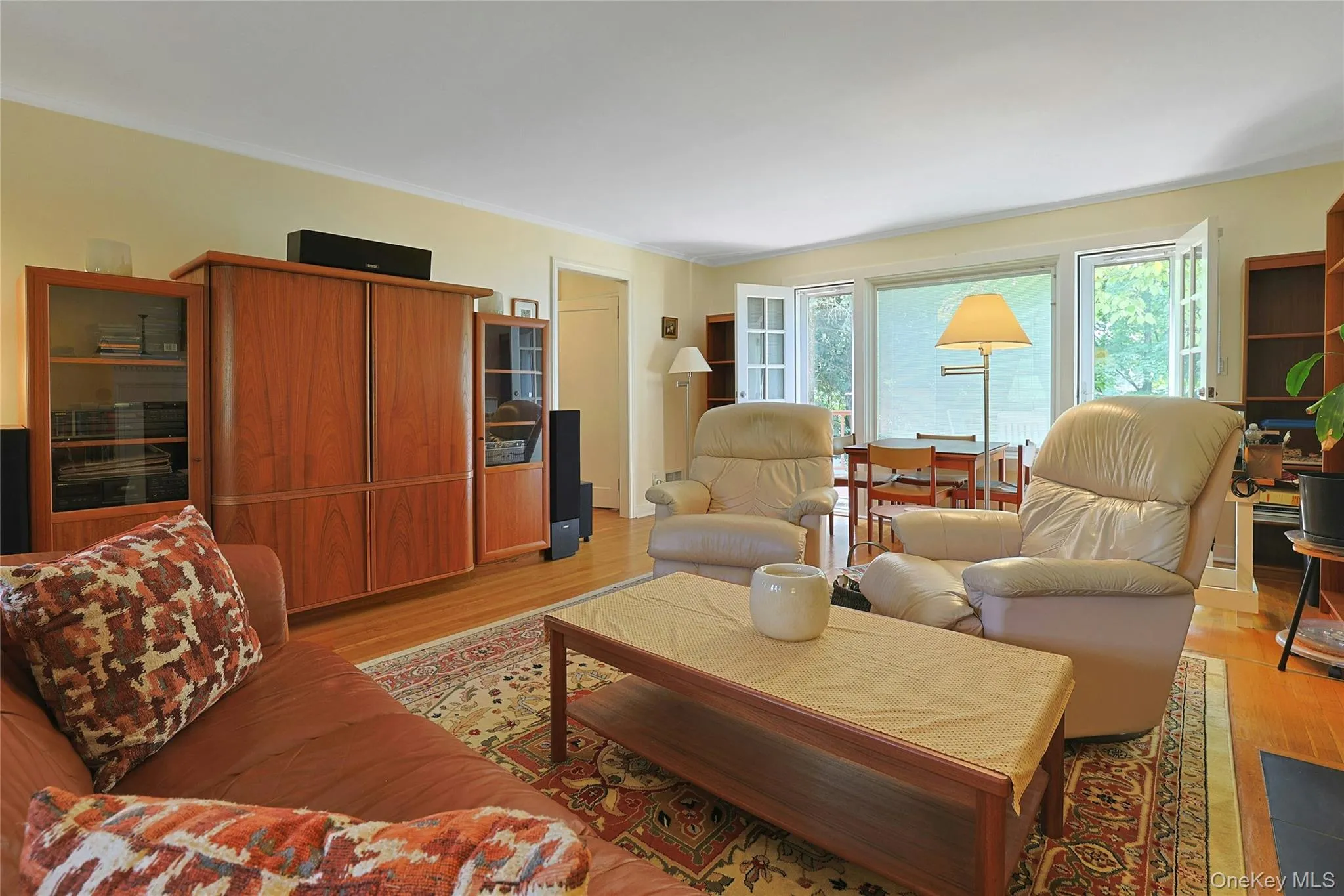 Another view of the Living Room showcasing the picture window and french doors leading to the wooden deck. Another view of the Living Room showcasing the picture window and french doors leading to the wooden deck.