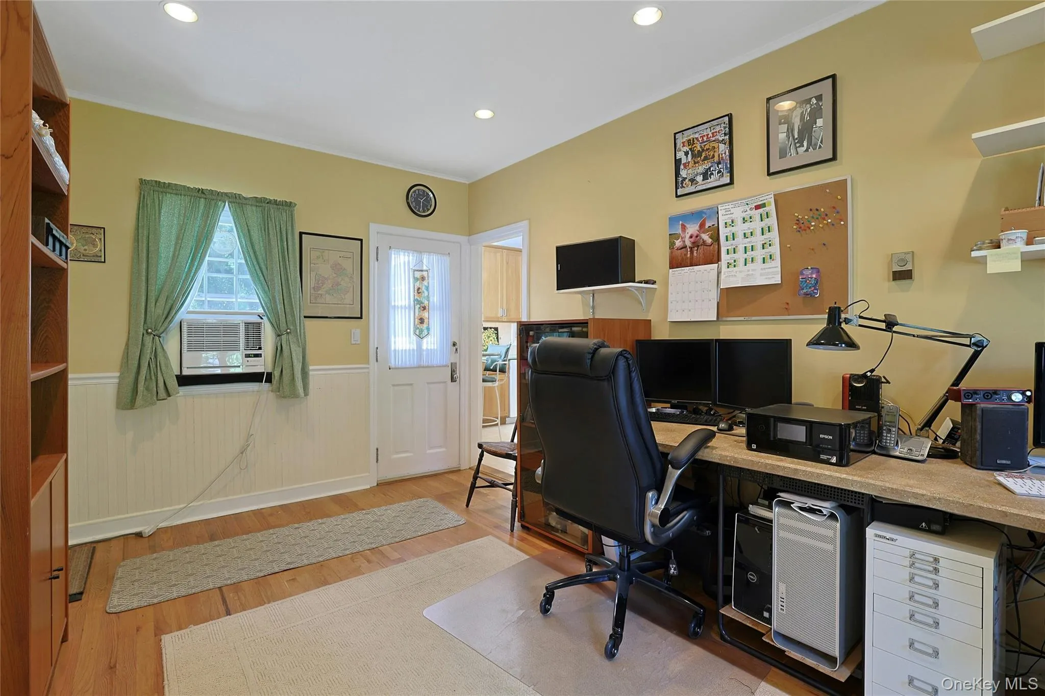 Another view of the Den/Office showing the recessed ceiling lighting, hardwood flooring, wainscoting, and a door leading out to the backyard and a door leading to the garage. Another view of the Den/Office showing the recessed ceiling lighting, hardwood flooring, wainscoting, and a door leading out to the backyard and a door leading to the garage.