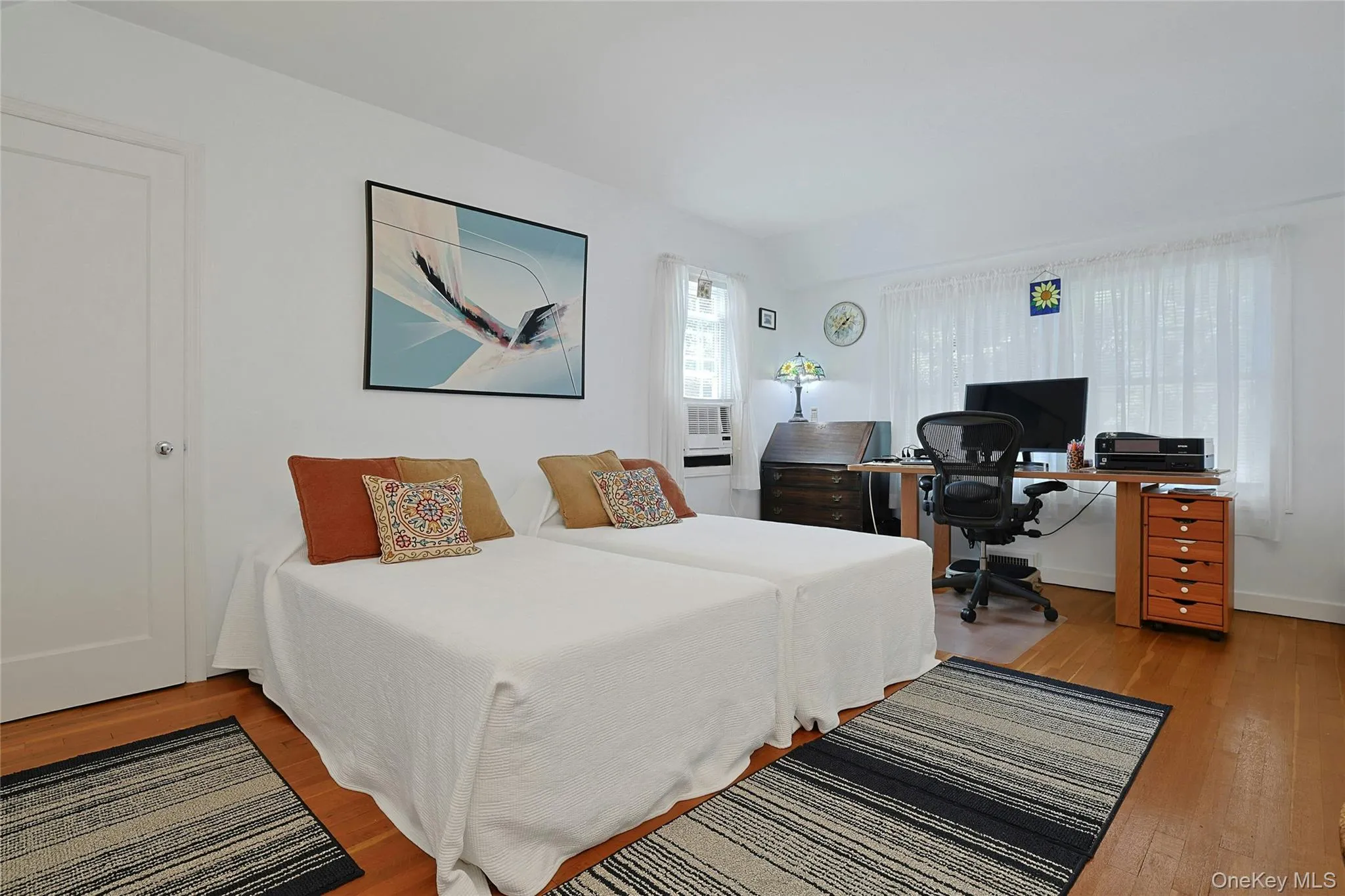 Second generously sized bedroom featuring hardwood flooring, multiply windows for an abundance of natural light. This bedroom also has a walk-in closet. Second generously sized bedroom featuring hardwood flooring, multiply windows for an abundance of natural light. This bedroom also has a walk-in closet.