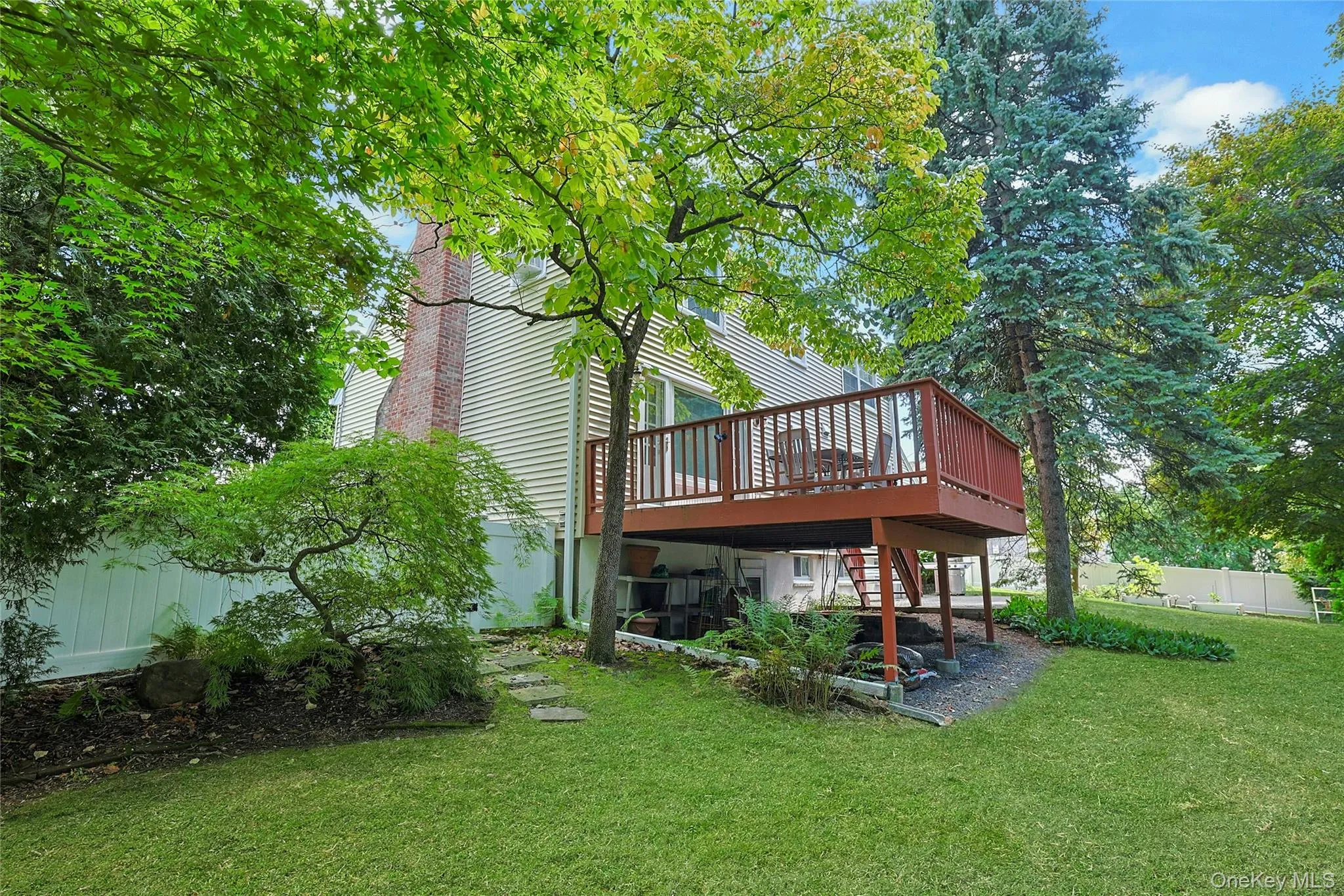 Back of Structure featuring the wooden deck, manicured lawn and privacy fence that surrounds the property. Back of Structure featuring the wooden deck, manicured lawn and privacy fence that surrounds the property.