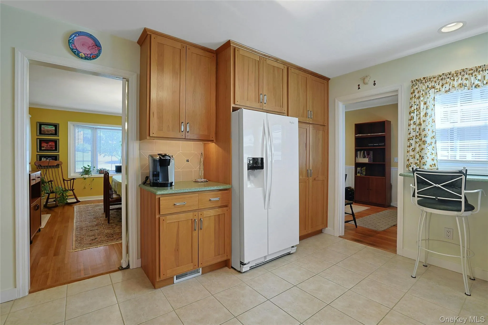 View of the Kitchen showing the rest of the cabinetry, door to the Formal Dining Room and Den. View of the Kitchen showing the rest of the cabinetry, door to the Formal Dining Room and Den.