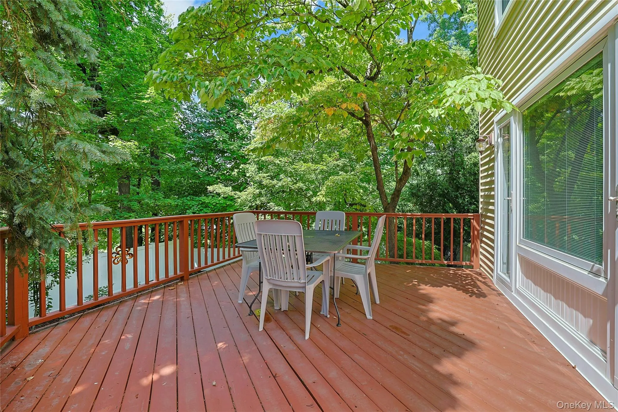 Expansive wood deck with a full railing system off the Living Room overlooking the backyard. Expansive wood deck with a full railing system off the Living Room overlooking the backyard.
