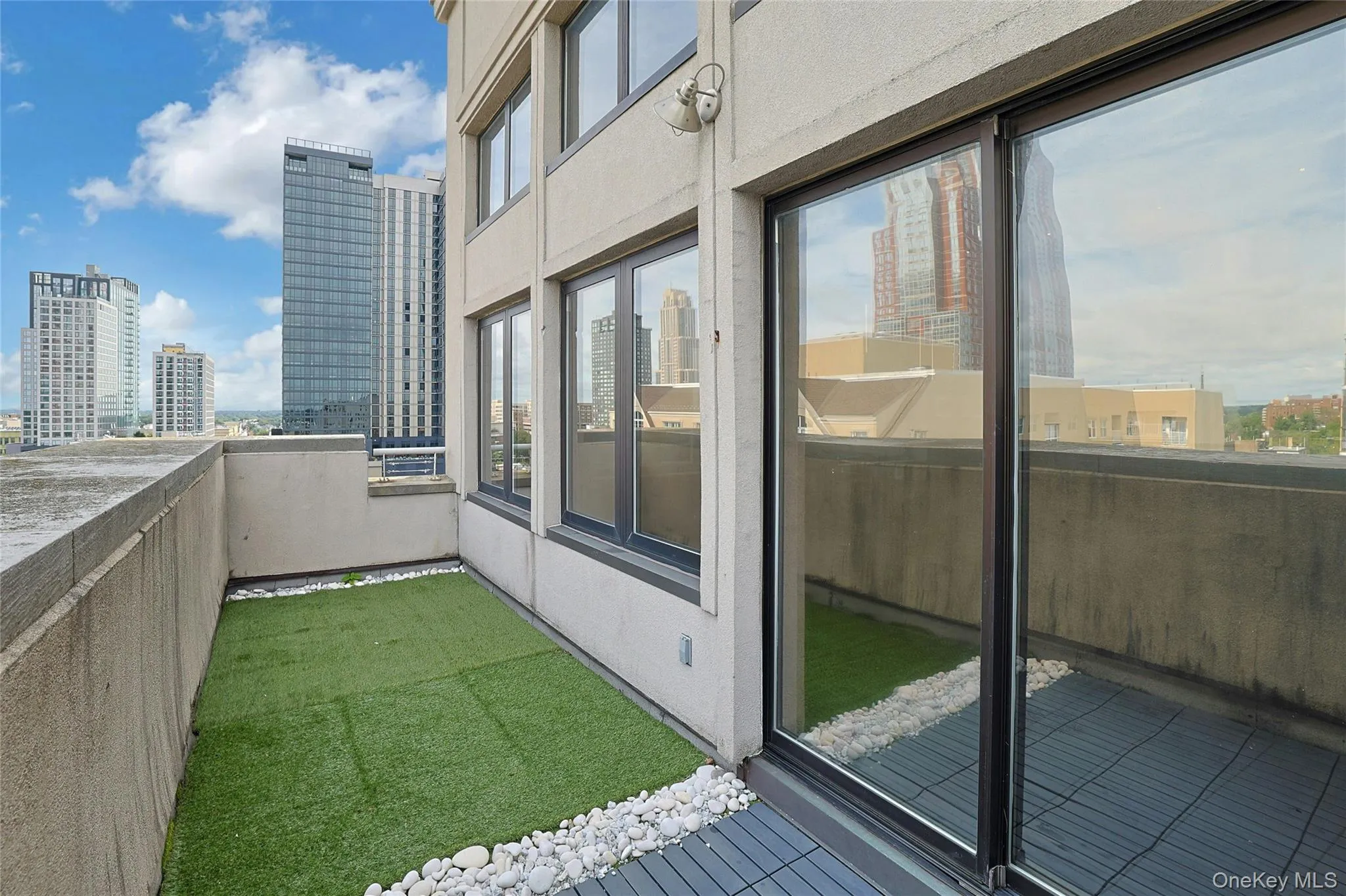 Spacious private terrace with turf, direct interior access, and impressive downtown views. Spacious private terrace with turf, direct interior access, and impressive downtown views.