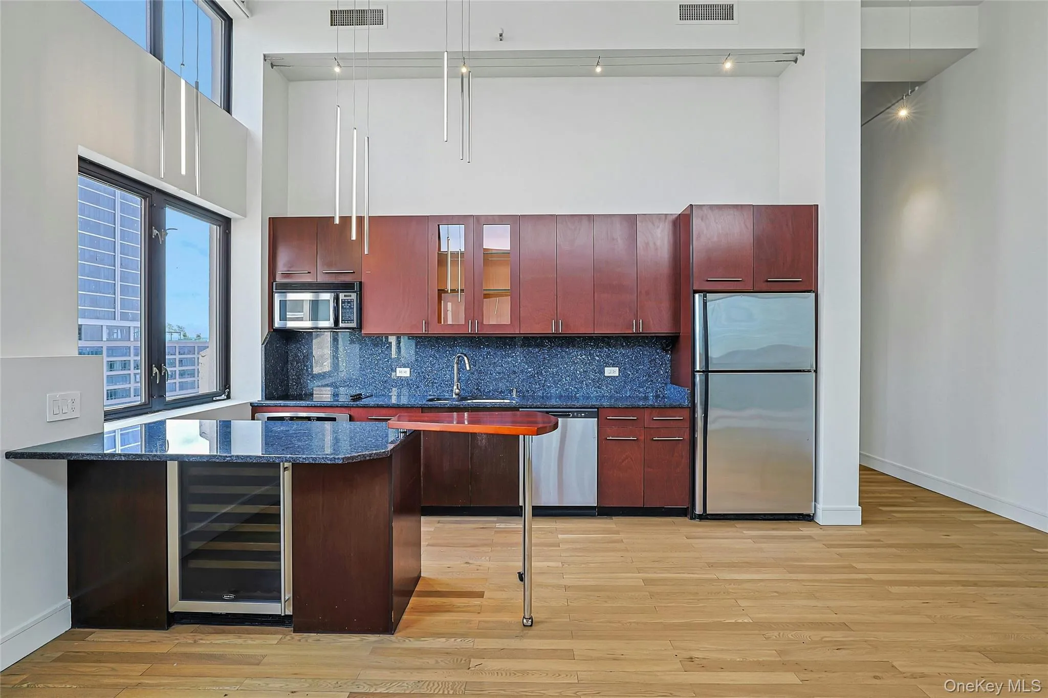 Open kitchen with center island and breakfast seating overlooking the main living and dining area. Open kitchen with center island and breakfast seating overlooking the main living and dining area.