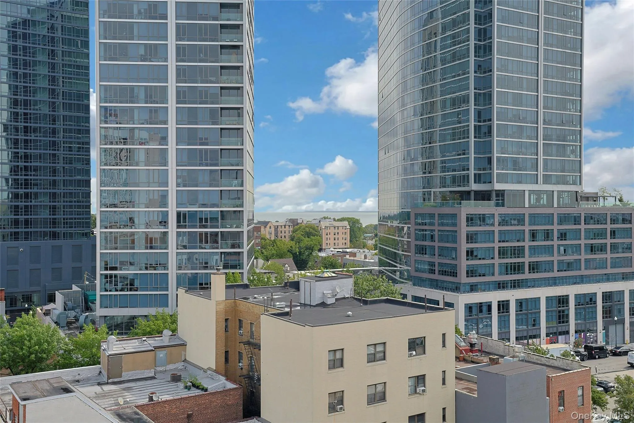 Elevated city views showcasing the surrounding downtown New Rochelle skyline and views of the Long Island Sound. Elevated city views showcasing the surrounding downtown New Rochelle skyline and views of the Long Island Sound.