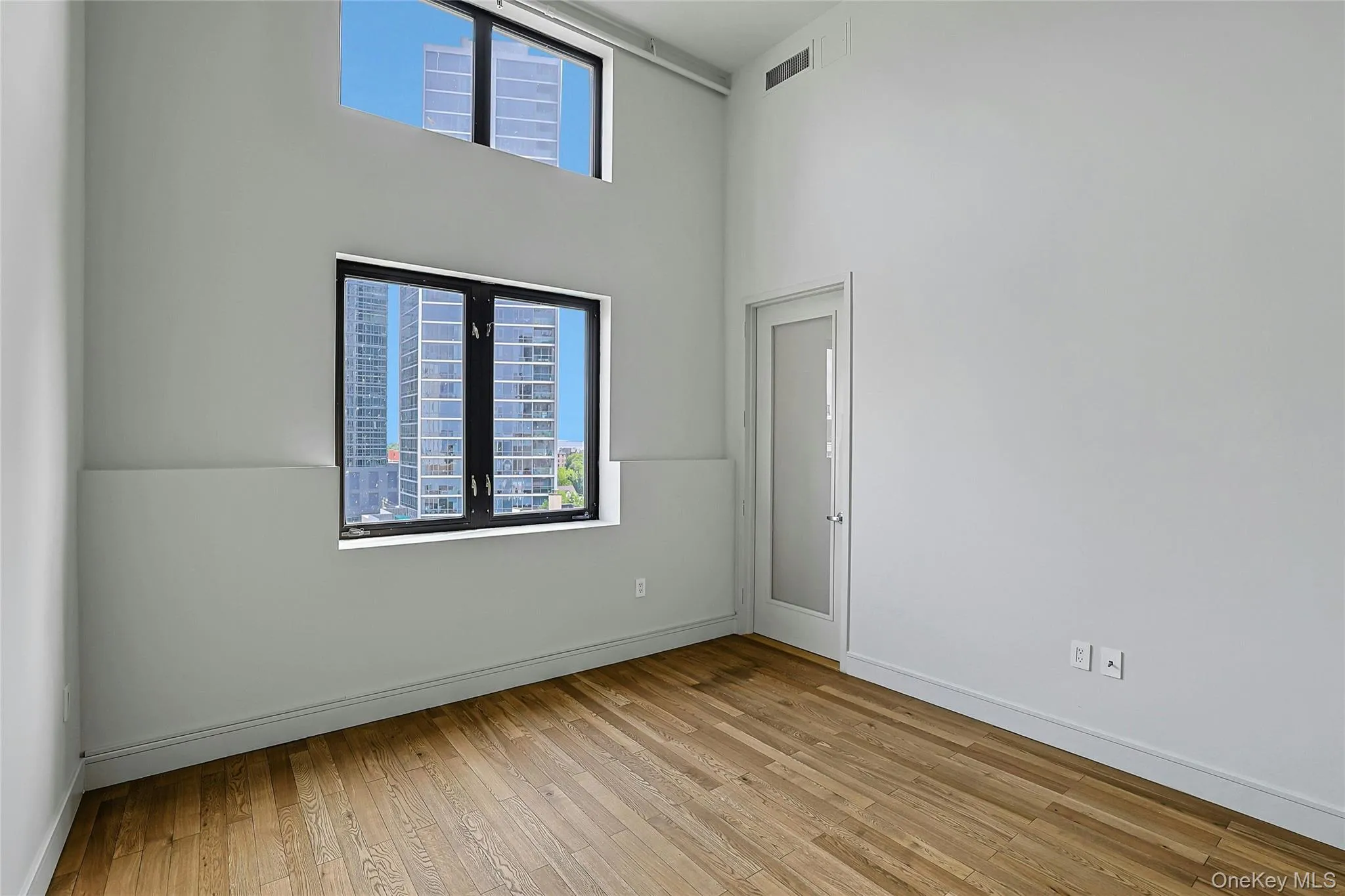 Versatile bedroom or home office with hardwood floors, high ceilings, and abundant natural light. Versatile bedroom or home office with hardwood floors, high ceilings, and abundant natural light.