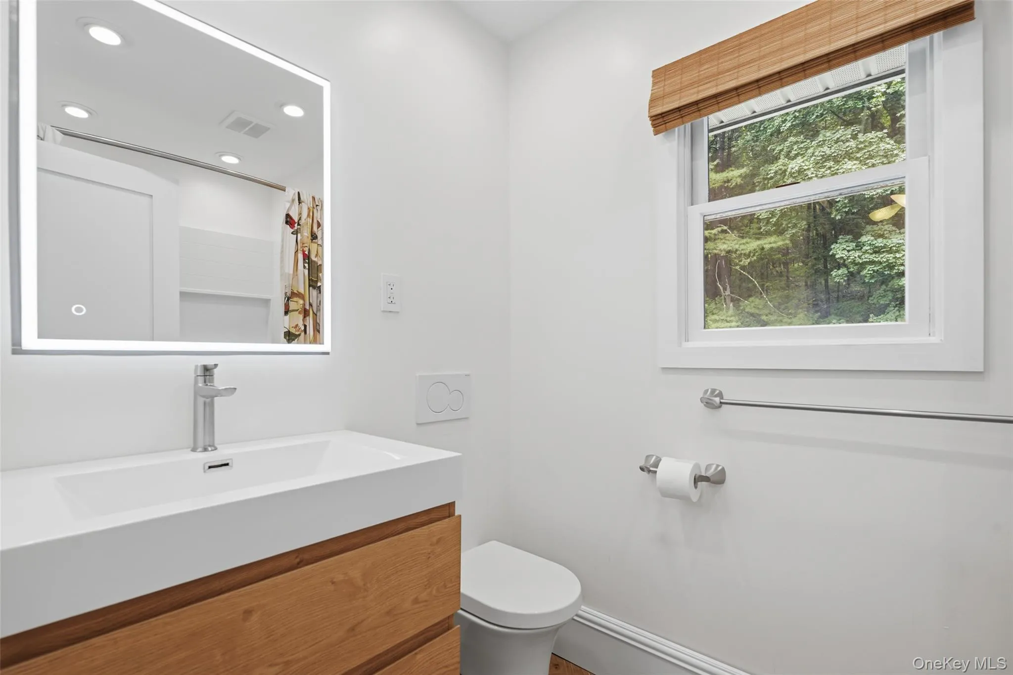 Floating vanity with wood-finish drawers, integrated rectangular sink, and chrome-finish faucet Floating vanity with wood-finish drawers, integrated rectangular sink, and chrome-finish faucet