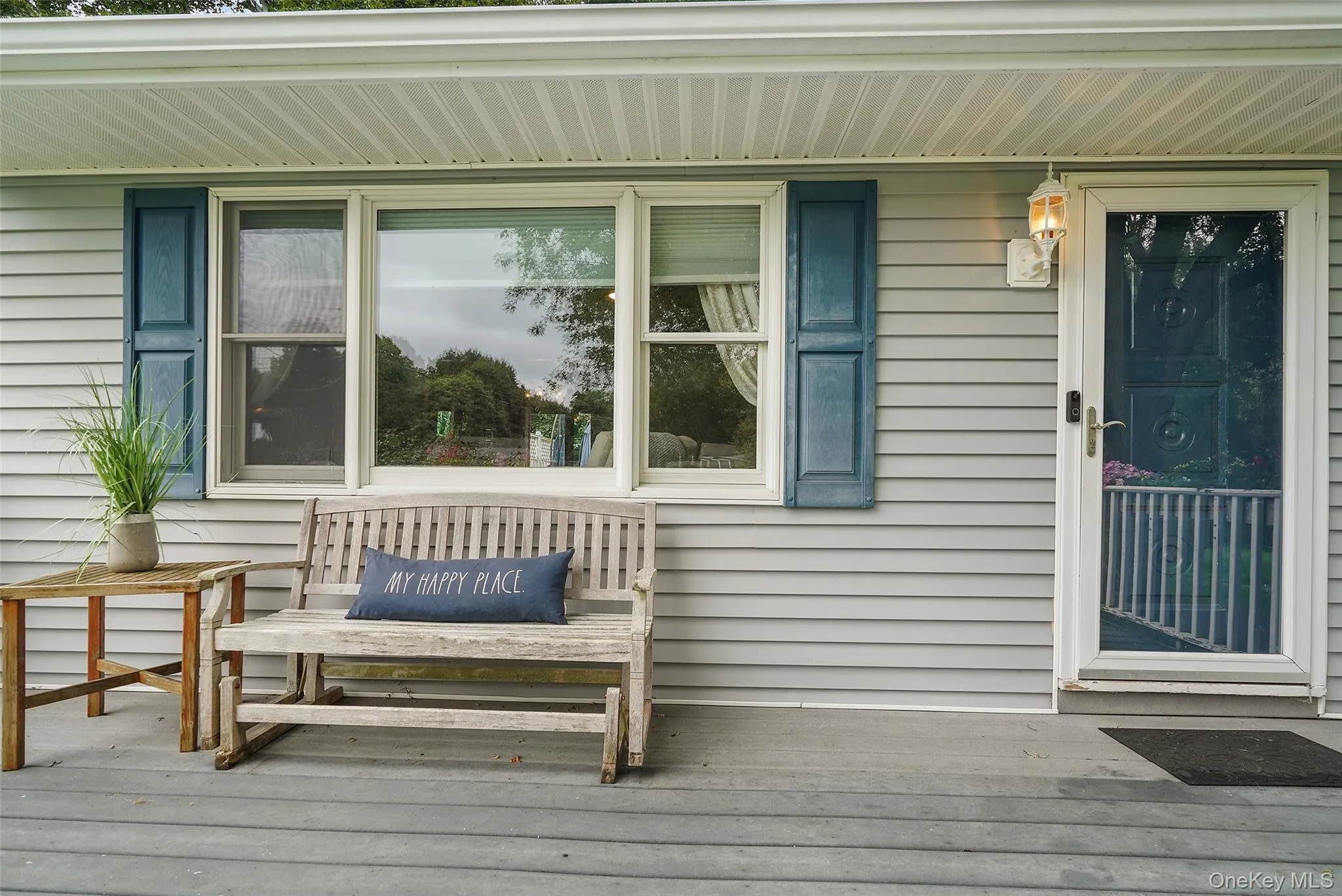 Light gray siding exterior with white trim and blue window shutters Light gray siding exterior with white trim and blue window shutters