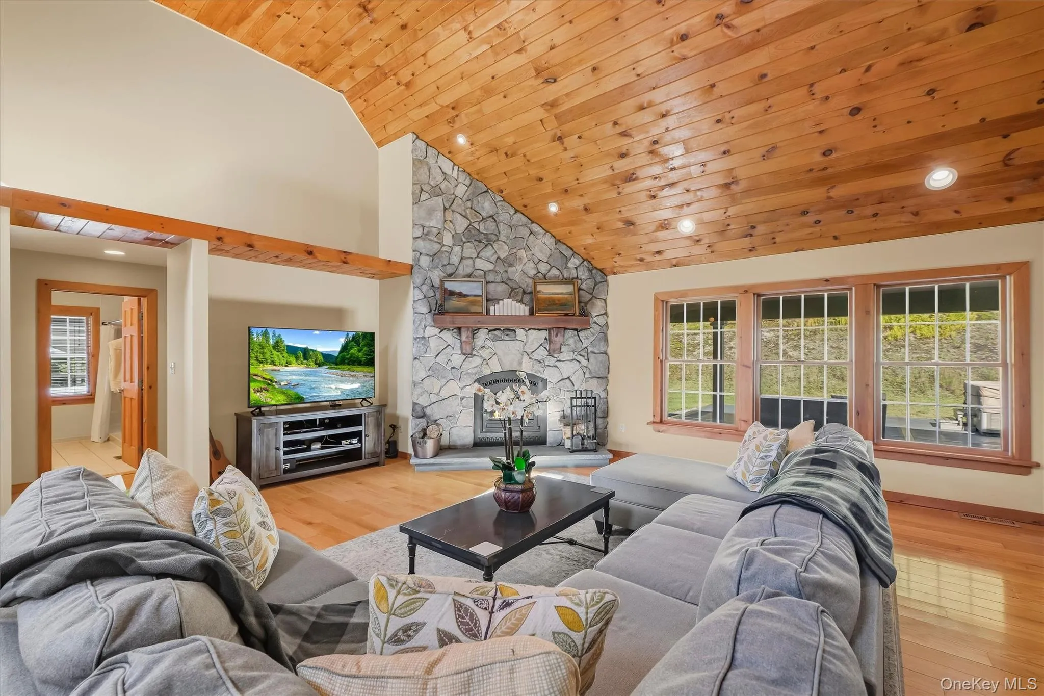 Vaulted ceiling with stone faced fireplace Vaulted ceiling with stone faced fireplace
