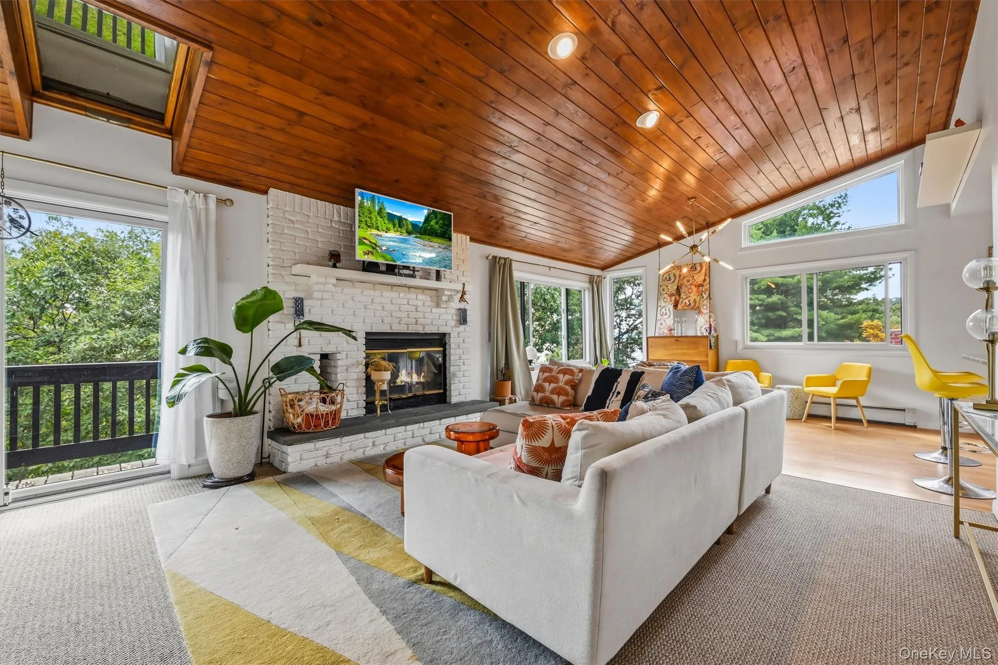 Accessory UnitLiving room with vaulted wood clad ceiling with skylights Accessory UnitLiving room with vaulted wood clad ceiling with skylights