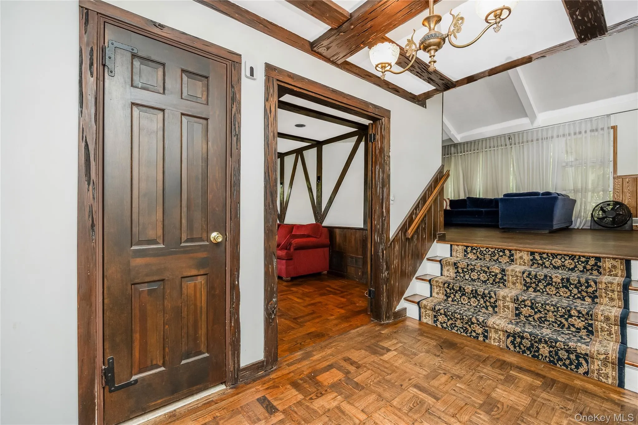 Wood-finish parquet flooring, exposed wood beams, and a vaulted ceiling Wood-finish parquet flooring, exposed wood beams, and a vaulted ceiling