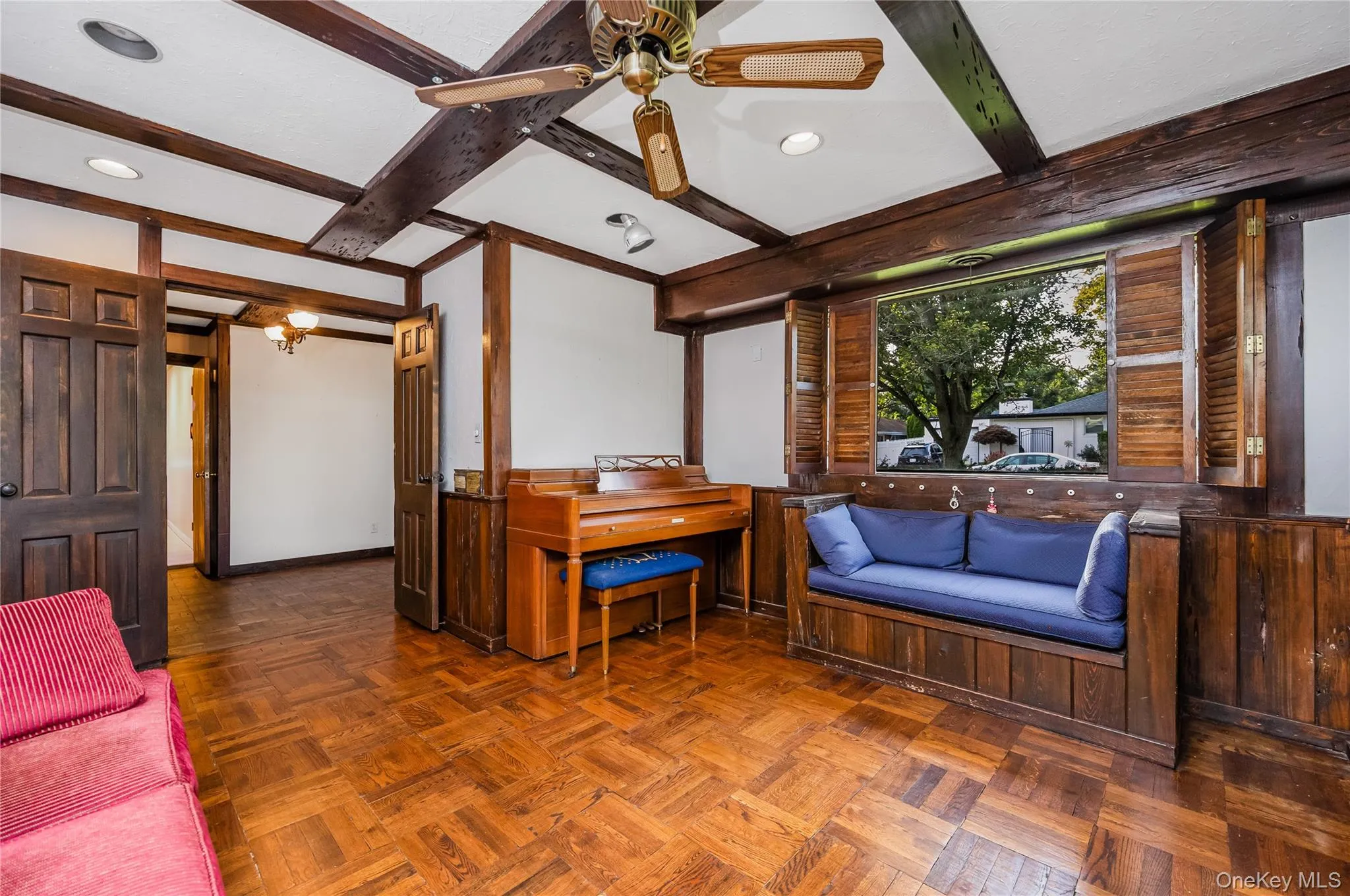 Wood-finish beamed ceiling, wood-finish flooring, wood-finish wall paneling, built-in shelving, and a built-in window seat. Potential 4th bedroom on main floor Wood-finish beamed ceiling, wood-finish flooring, wood-finish wall paneling, built-in shelving, and a built-in window seat. Potential 4th bedroom on main floor