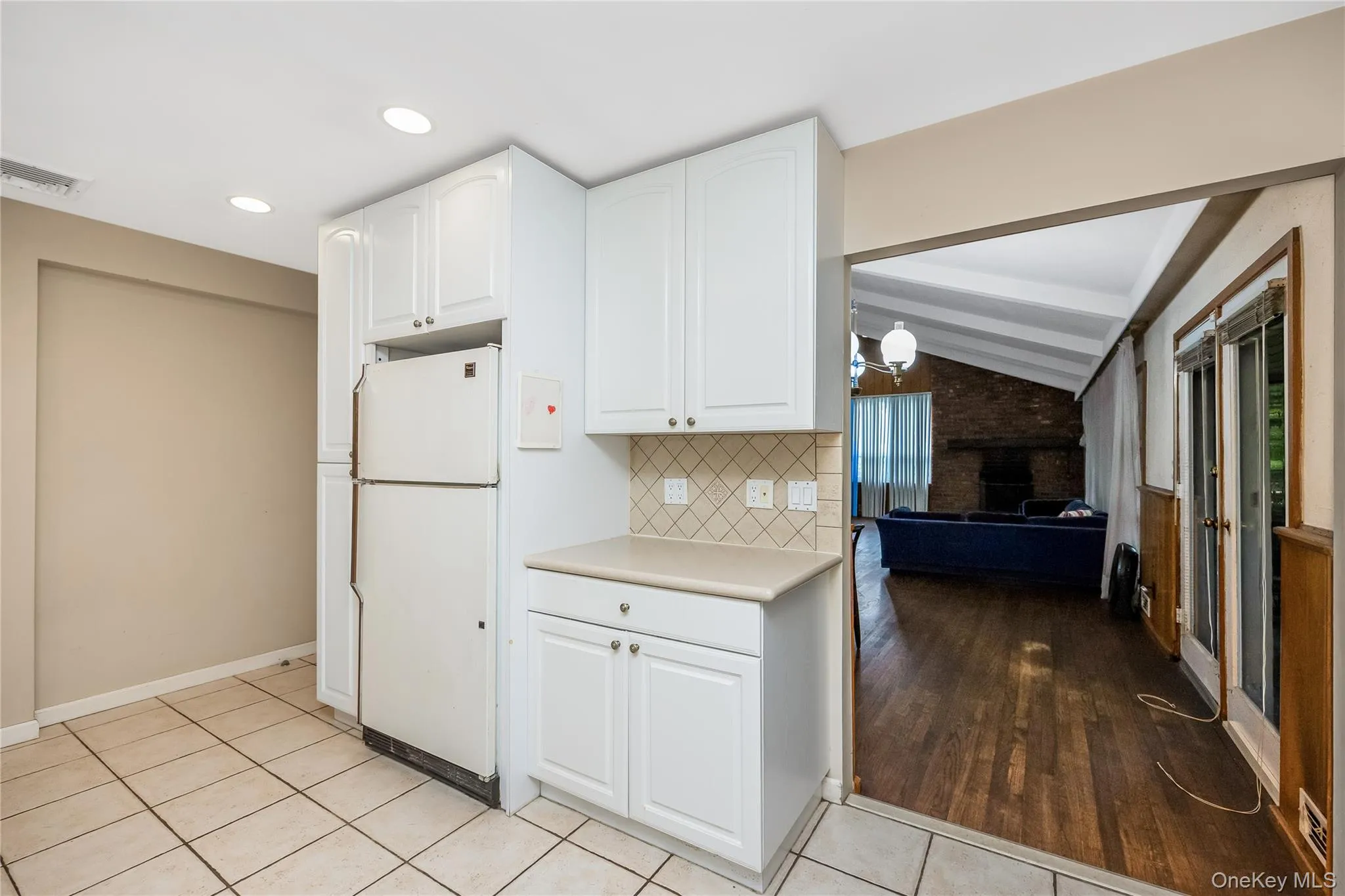Eat in Kitchen featuring white cabinetry, tile backsplash, stainless steel sink, and recessed lighting Eat in Kitchen featuring white cabinetry, tile backsplash, stainless steel sink, and recessed lighting